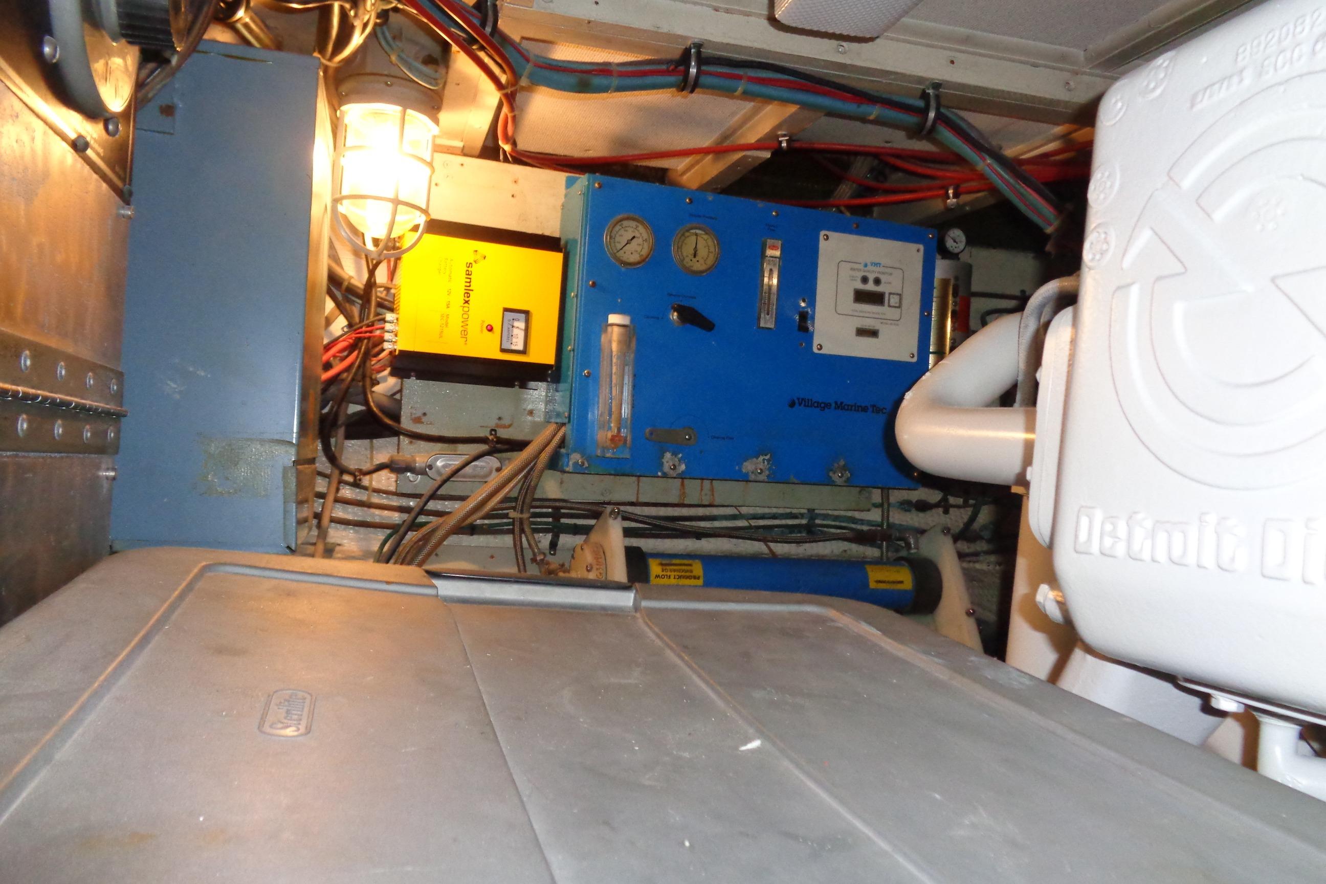 Engine room of 1981 Hatteras 48 Cockpit Motor Yacht with electrical equipment and wiring.