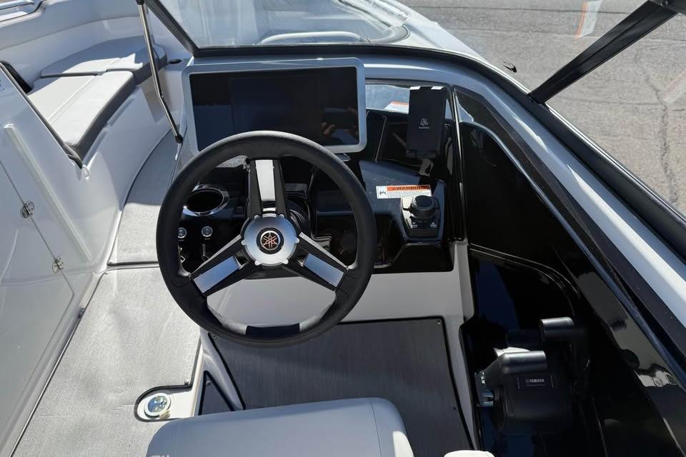 2026 Yamaha Boats AR250 cockpit with steering wheel and modern dashboard controls.