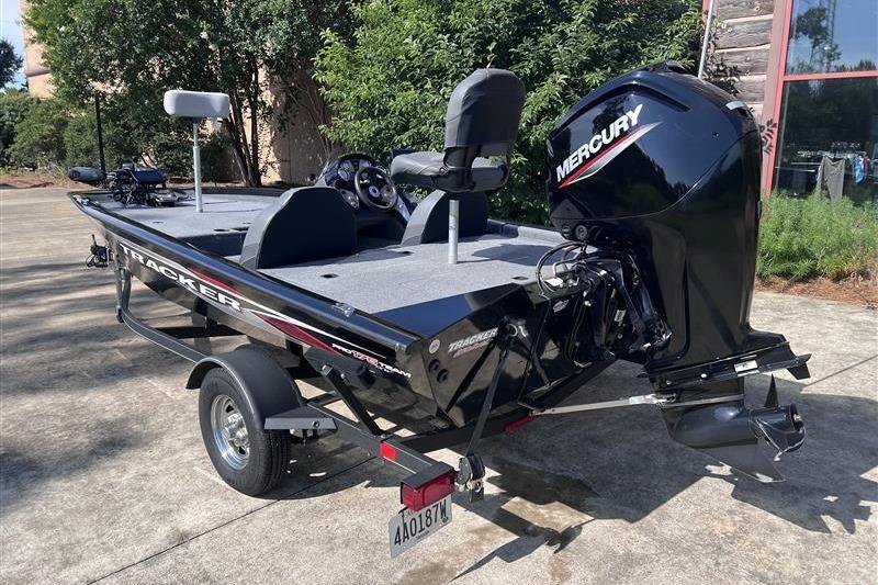 2021 Tracker Pro Team 175 TXW boat with Mercury engine on trailer, parked outdoors.