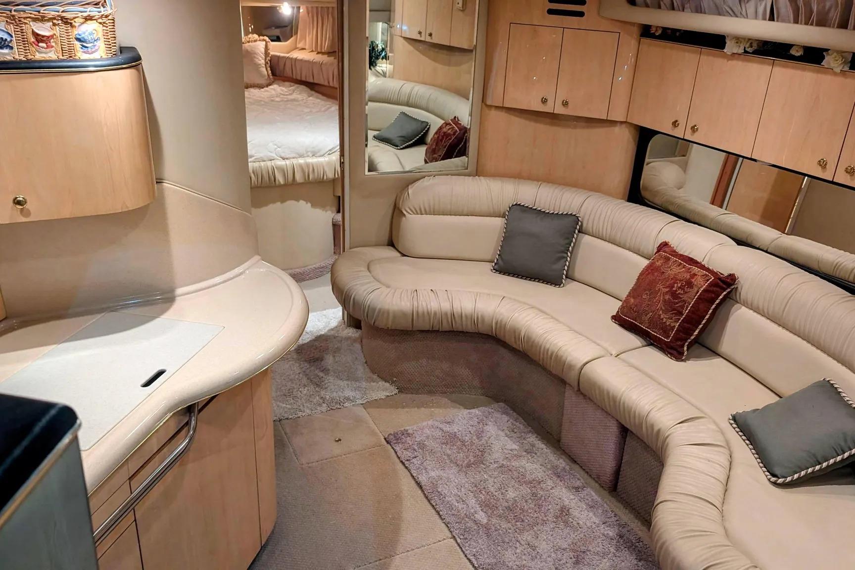 Luxurious interior of 2000 Sea Ray 380 Sundancer yacht with plush seating and elegant decor.