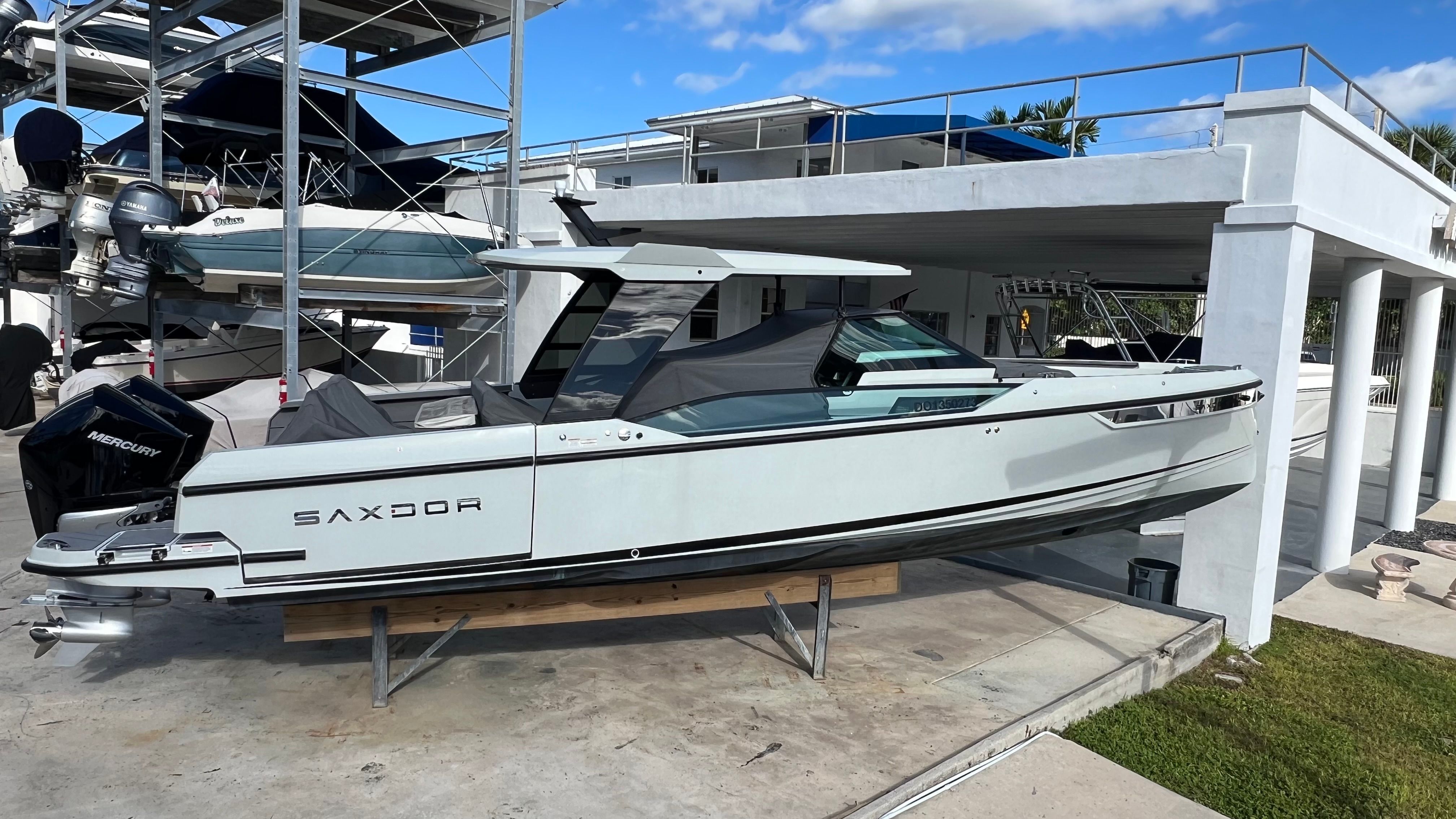 2024 Saxdor 320 GTO motorboat on a boat stand.