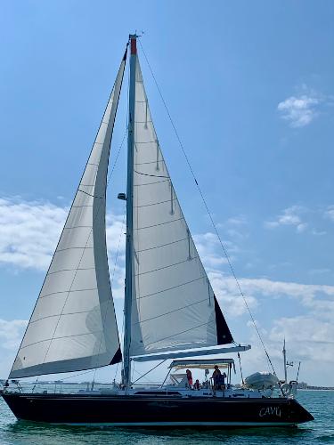 1989 Concordia 52 sailboat with white sails on a sunny day.