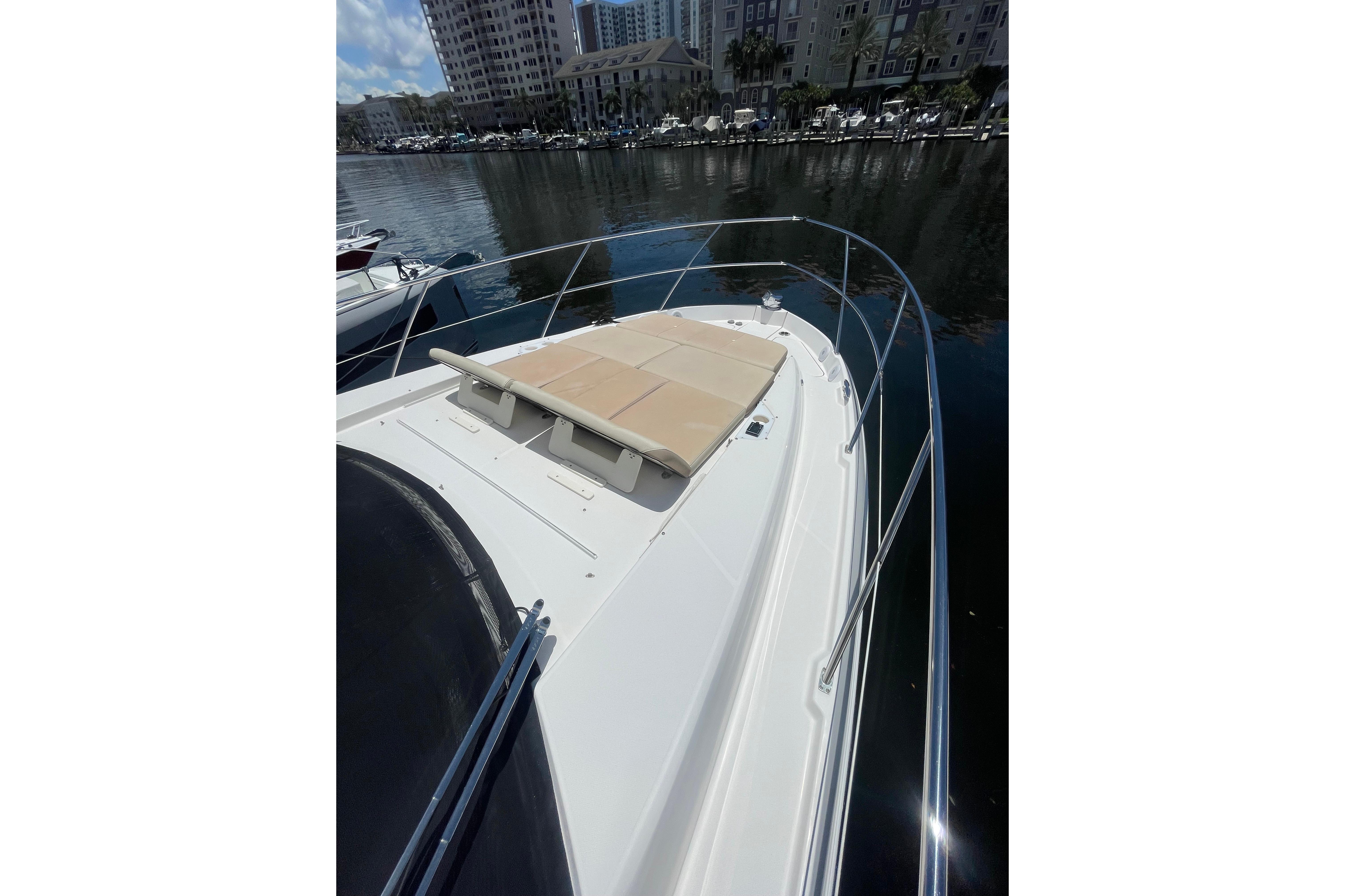 2020 Regal 42 Grande Coupe yacht with sunpad, docked in a marina.