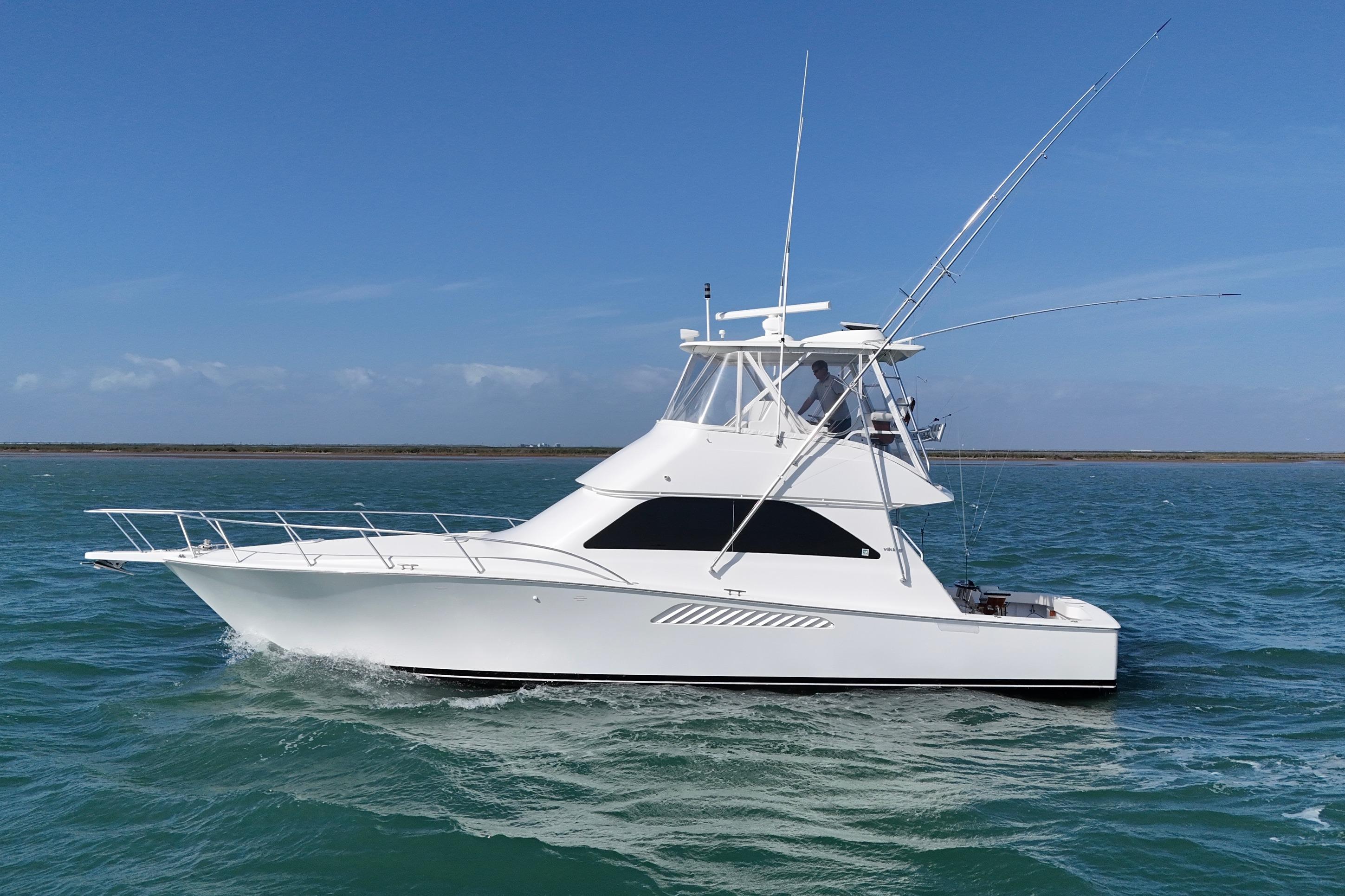 2008 Viking Convertible yacht cruising on open water under clear blue skies.