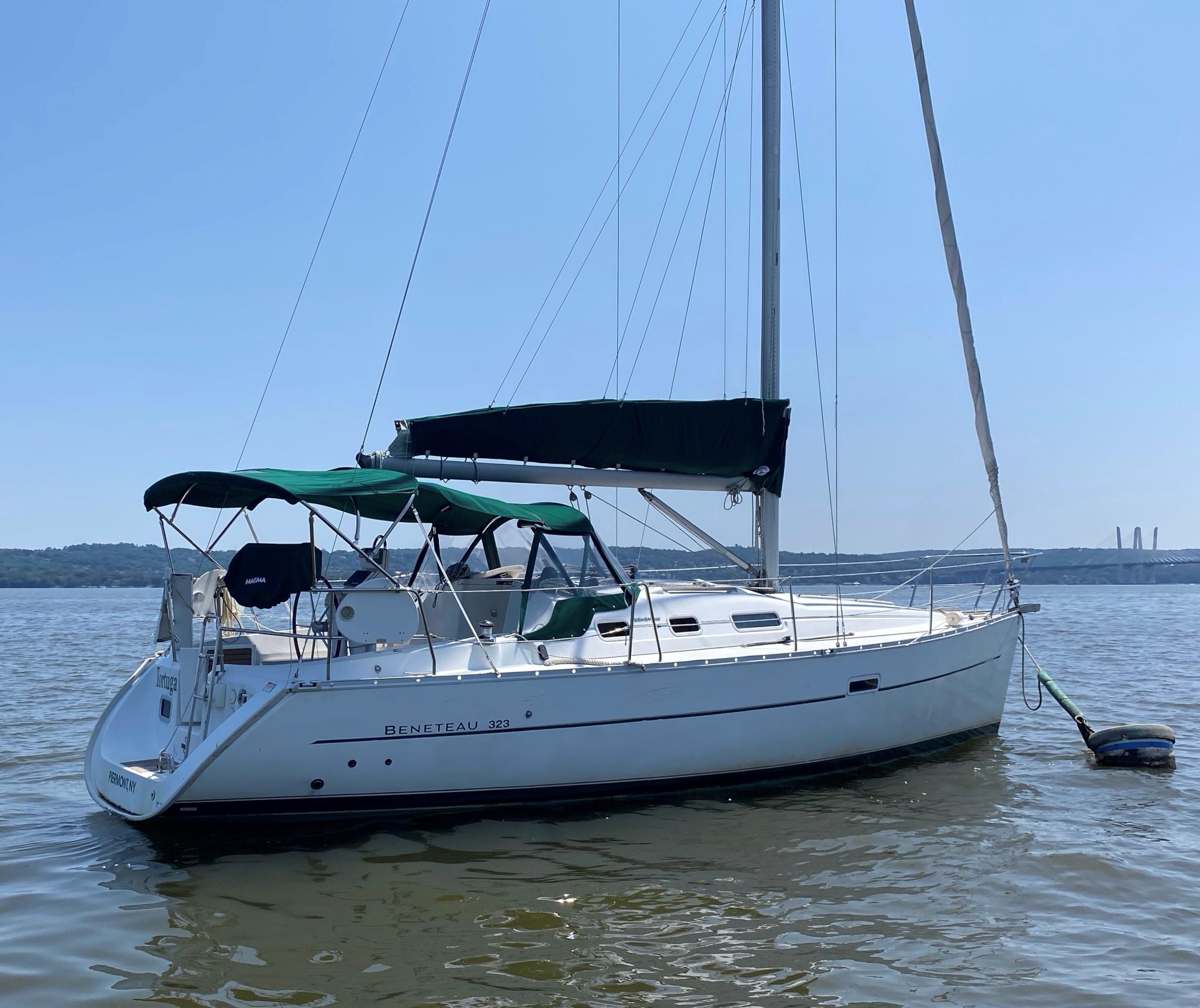 2005 Beneteau 323 sailboat on calm water.