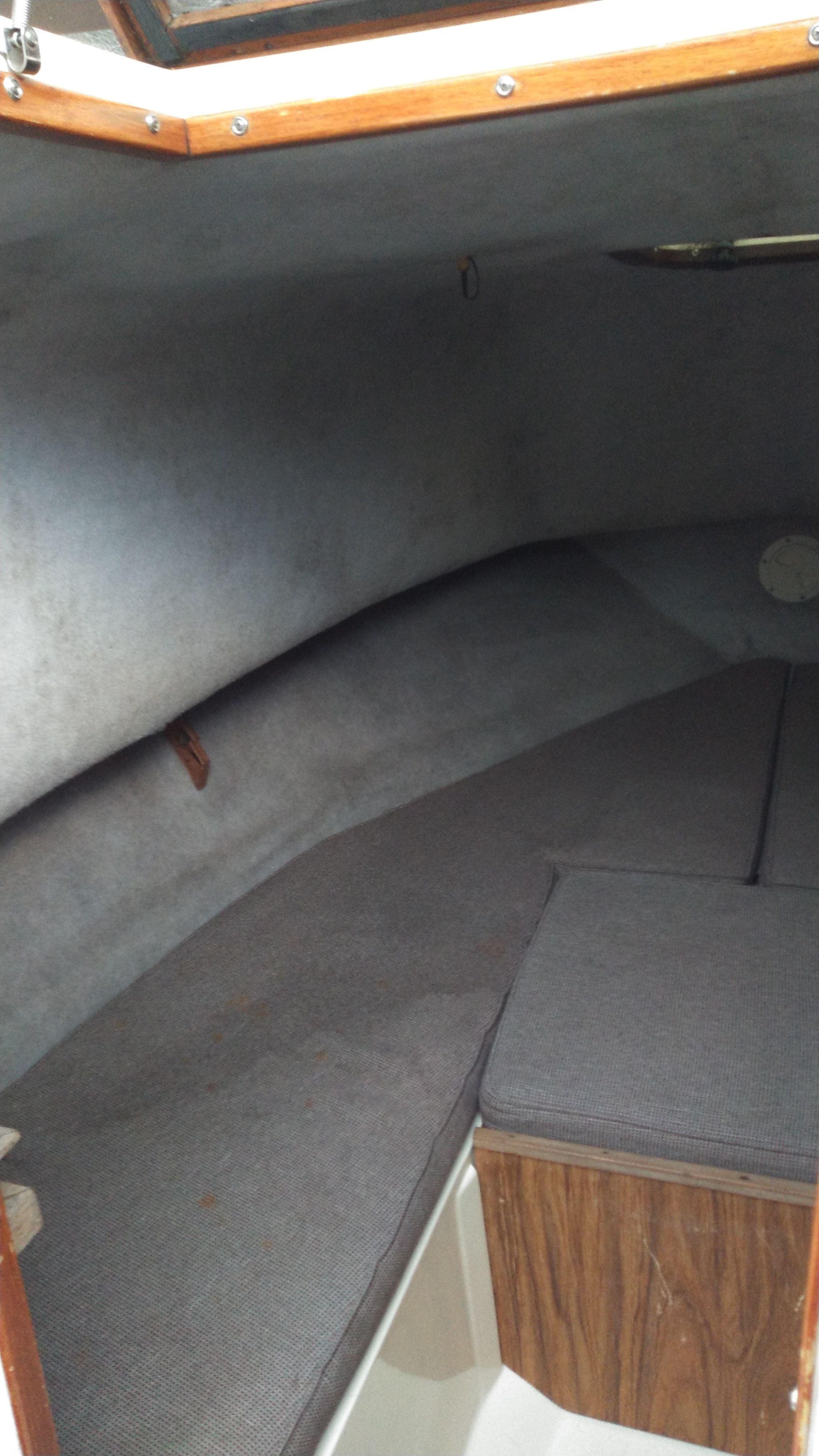 Interior of a 1989 Mako 240 Walk Around with gray upholstery.