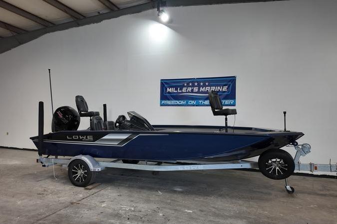 2024 Lowe Stinger 198 boat on trailer in showroom, Miller's Marine banner in background.
