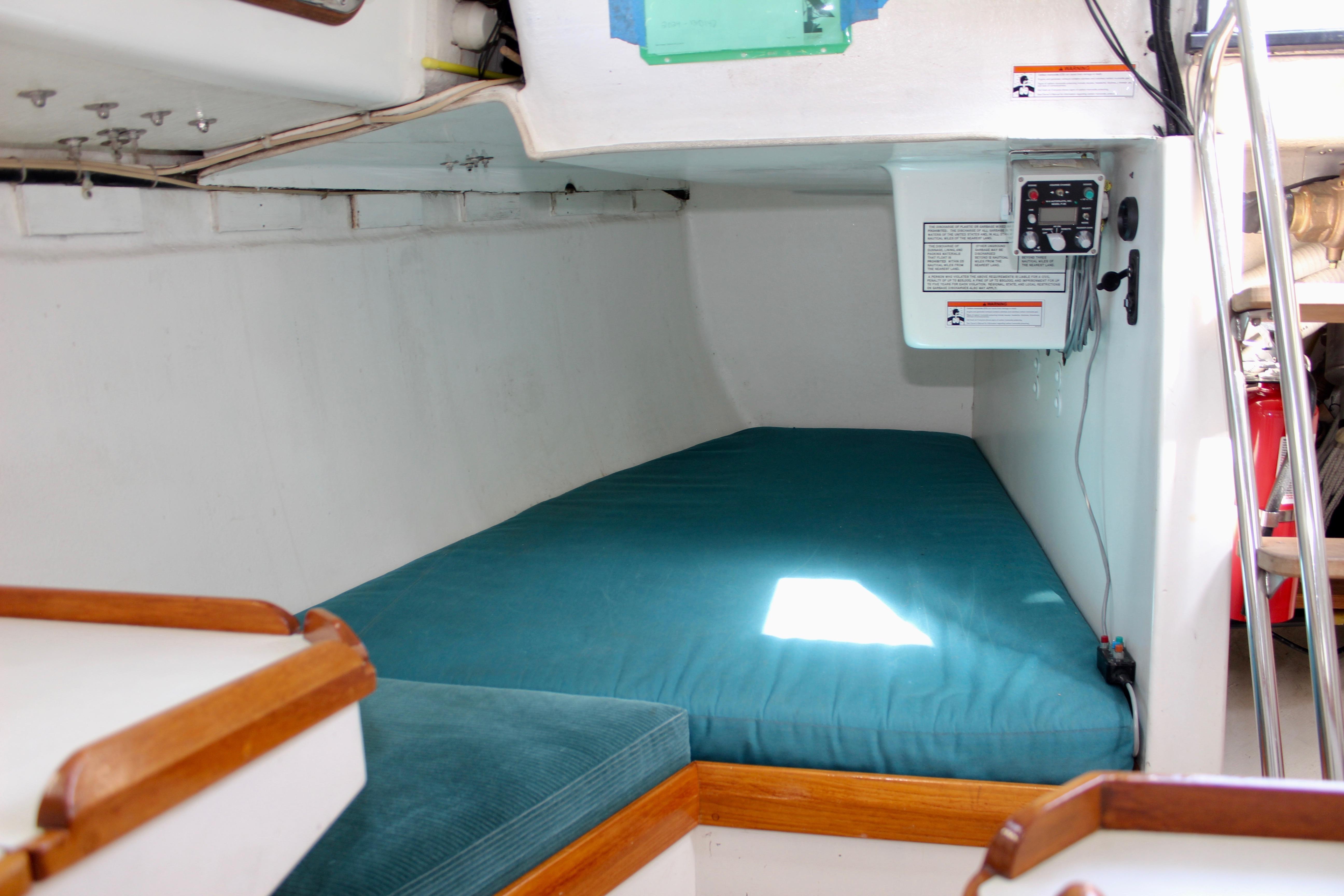 Interior cabin of 1993 Freya 39 sailboat with teal bedding and control panel.