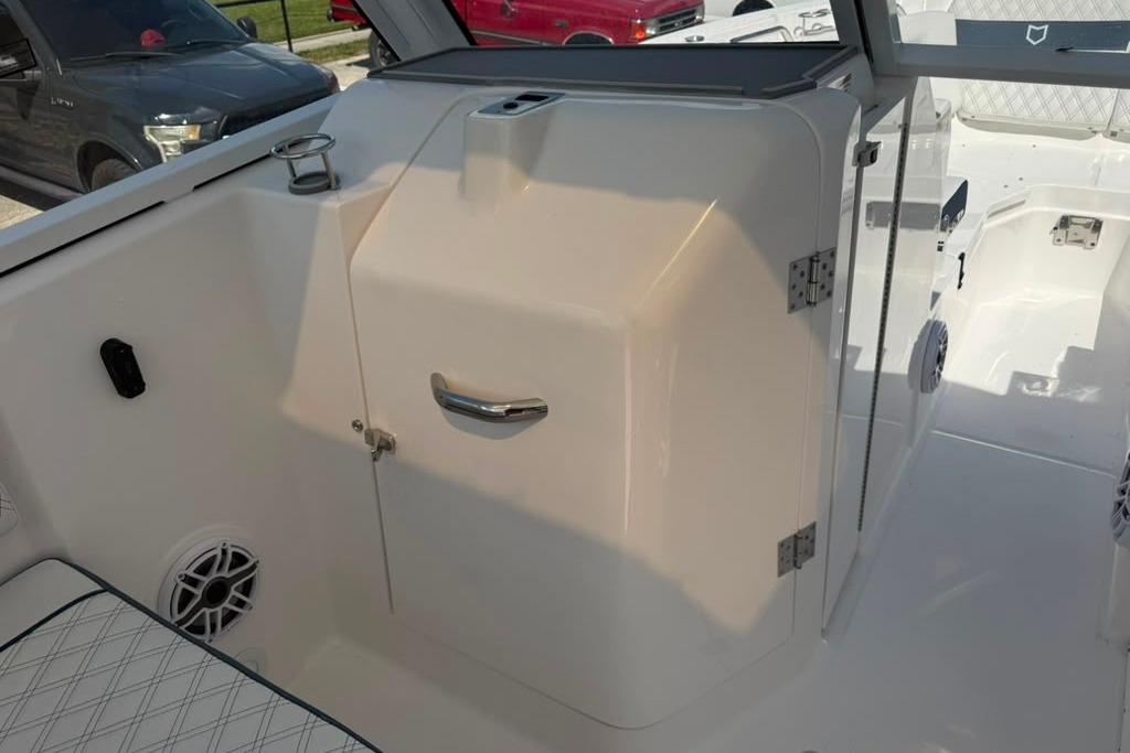 Interior view of 2026 Sea Fox 288 Traveler boat, featuring sleek white cabinetry and seating.
