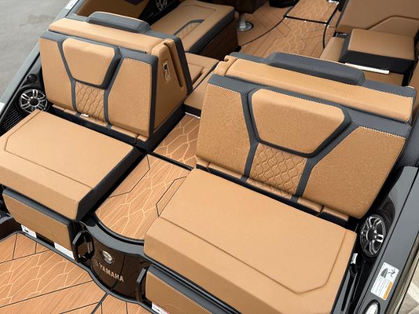 2025 Yamaha Boats 255XD interior with tan and black seating, showcasing modern design and comfort.