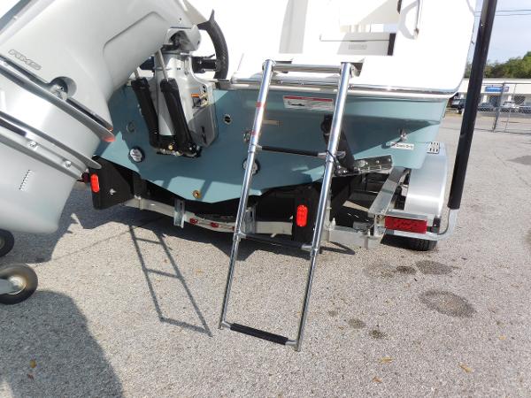 2025 Sailfish 232 CC boat with ladder and outboard motor on trailer.