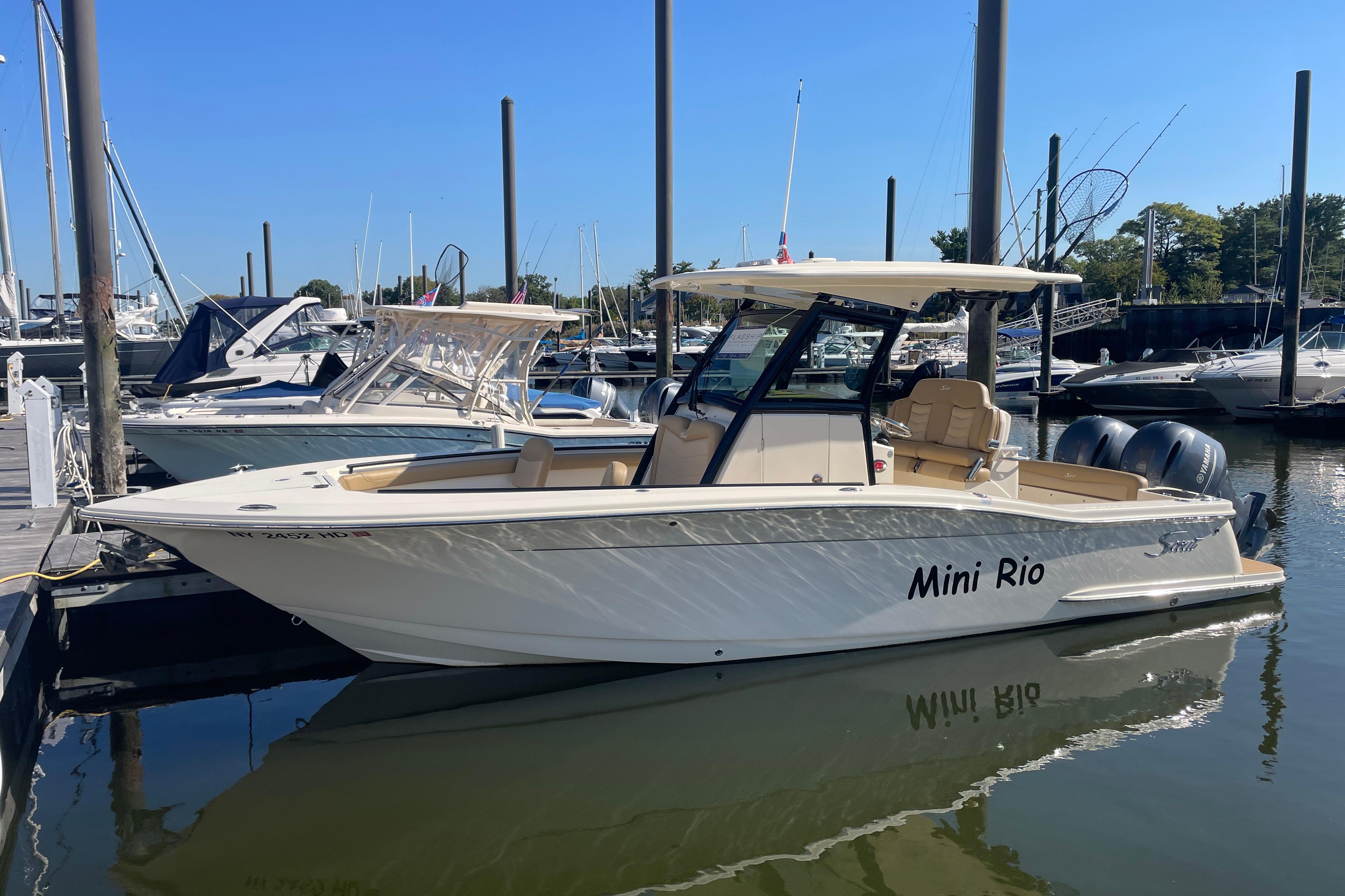 2020 Scout 255 LXF boat named "Mini Rio" docked at a marina.