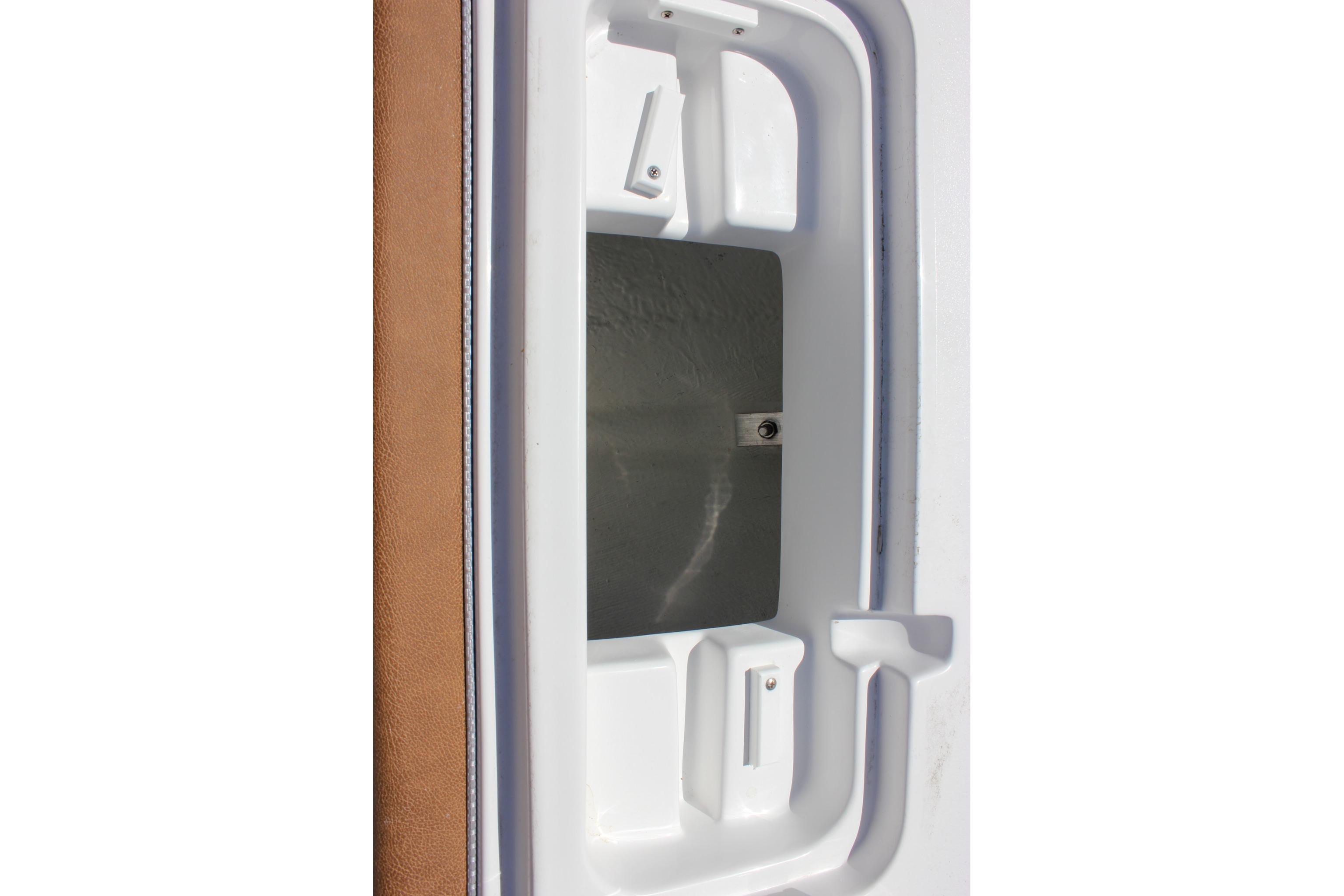 Compartment detail of 2027 Sea Hunt Ultra 234 boat, featuring white and brown interior.