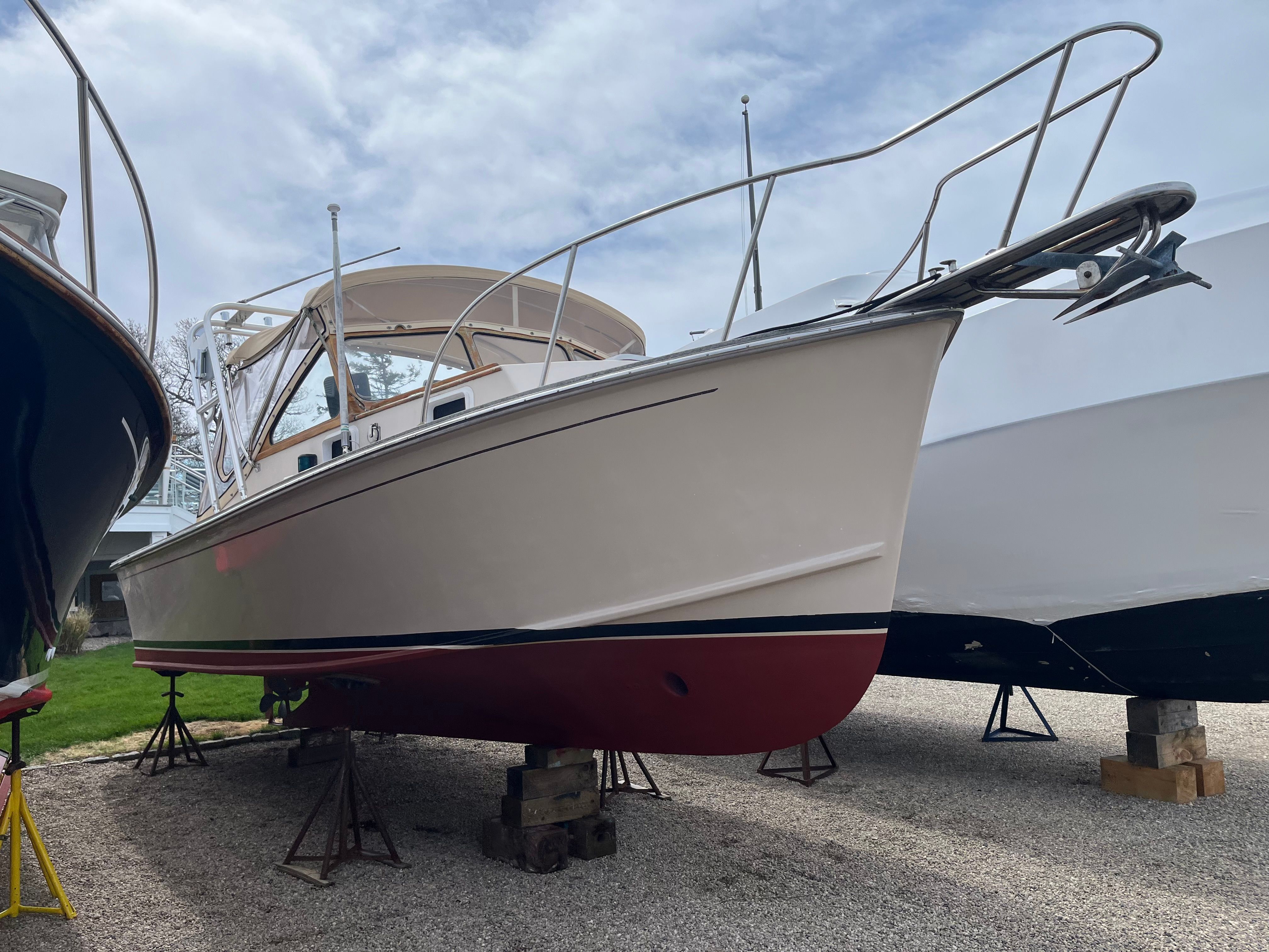 A 1989 Fortier 26 boat is on a dry dock.