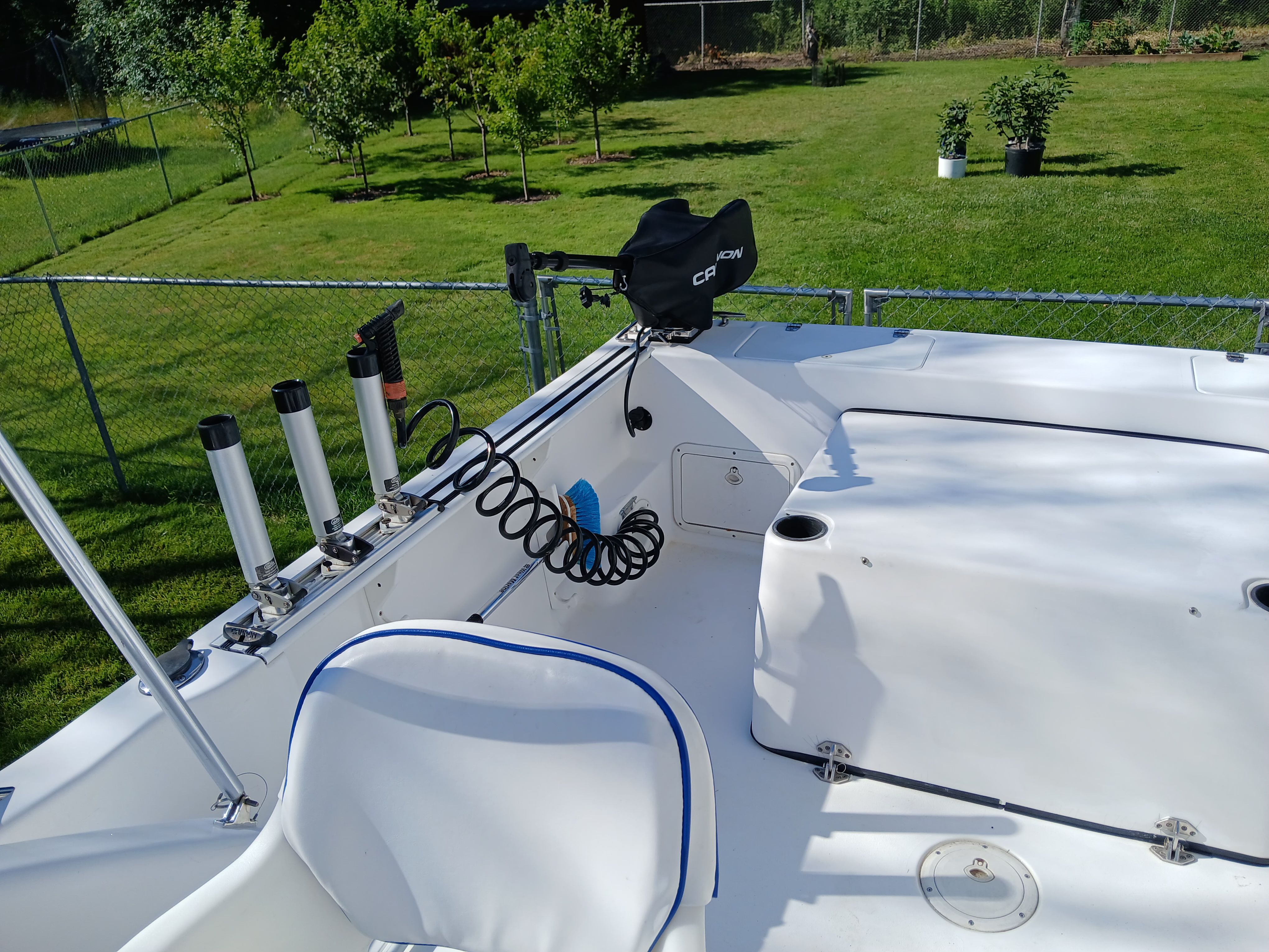 The image shows the deck of a 1999 Pro-Line 201 Walkaround boat on a lawn.