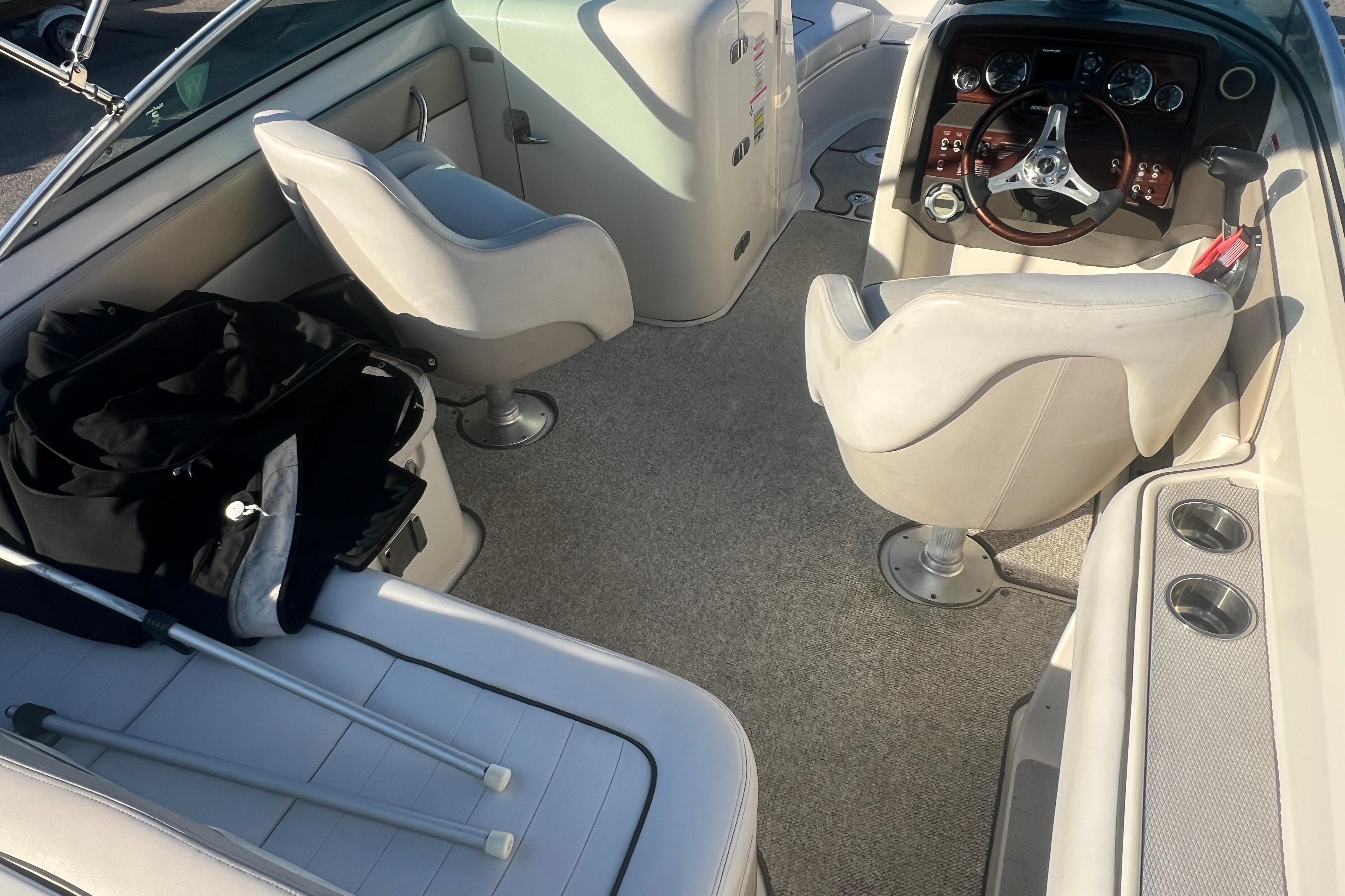 2009 Sea Ray 210 Sundeck interior with seating, steering wheel, and accessories.