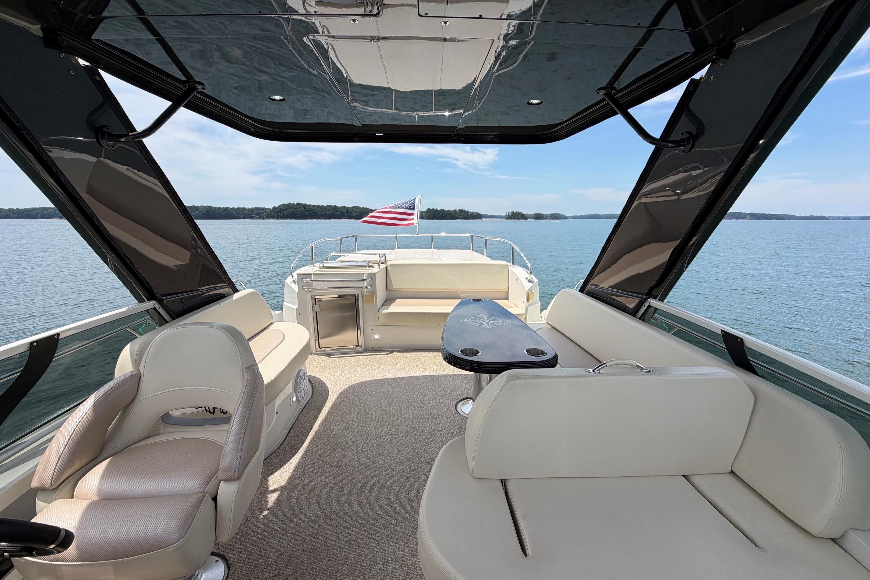 Luxurious 2011 Carver 44 Sojourn yacht interior with elegant seating and scenic water view.