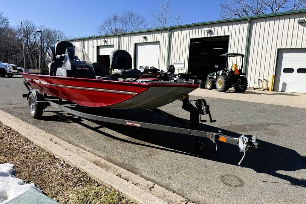 2026 Tracker Bass Tracker Classic XL boat on trailer outside a garage.