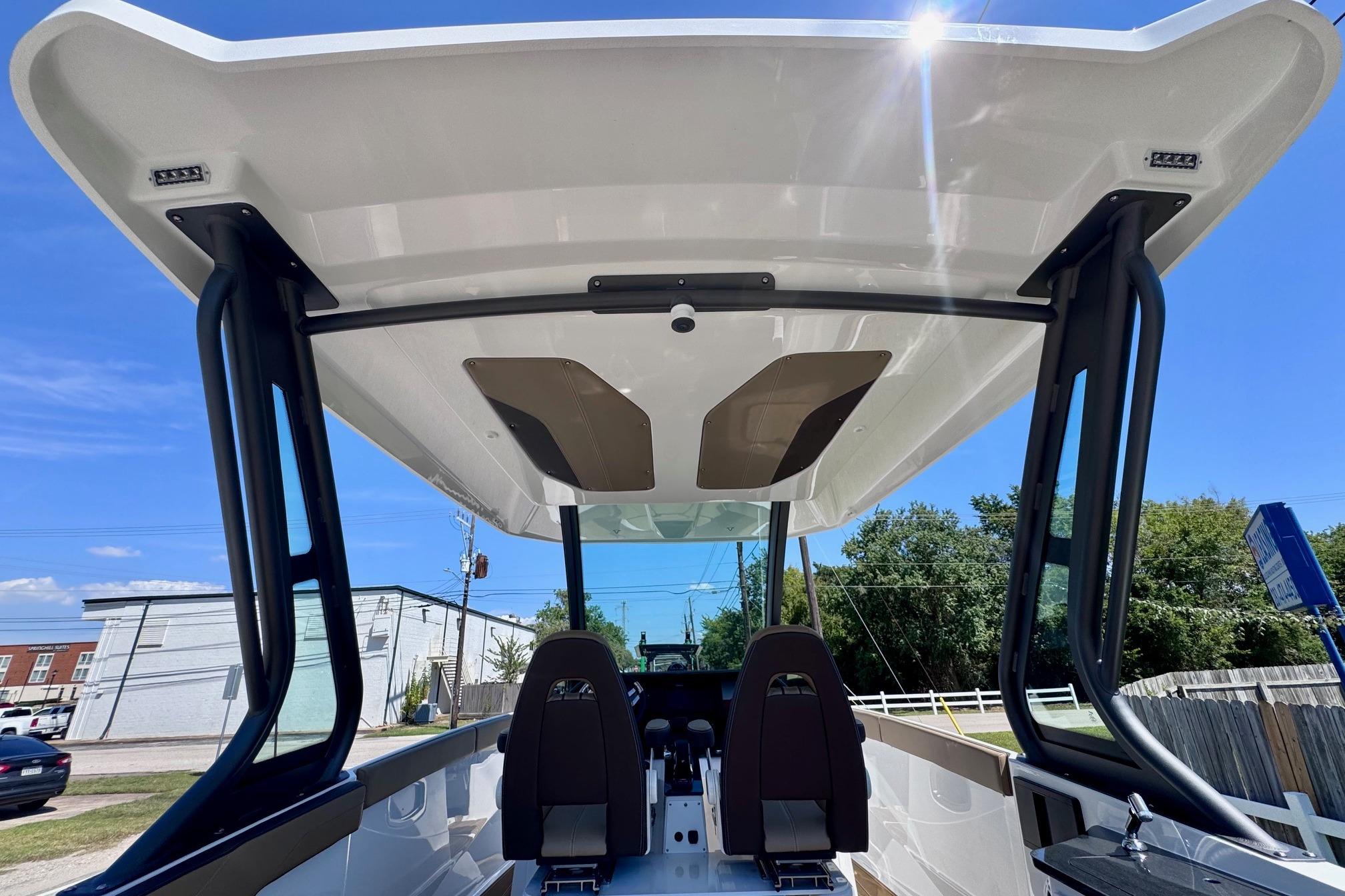 2026 Monterey Elite 27 OB boat interior with sleek design and modern features under a clear blue sky.