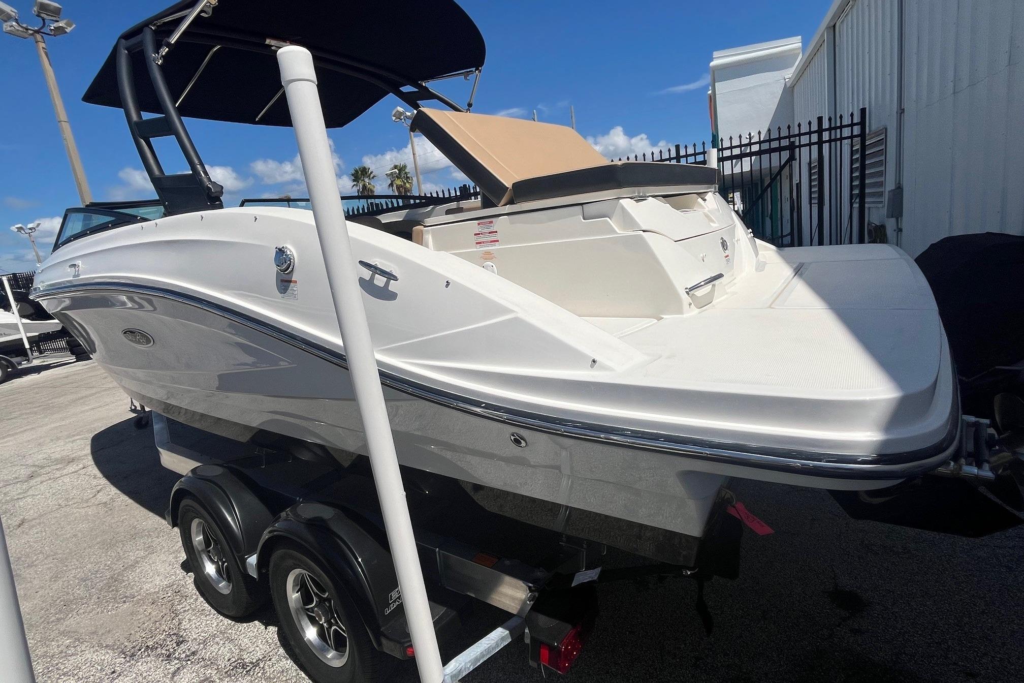 2024 Sea Ray SPX 230 boat on trailer, white exterior, parked outdoors.