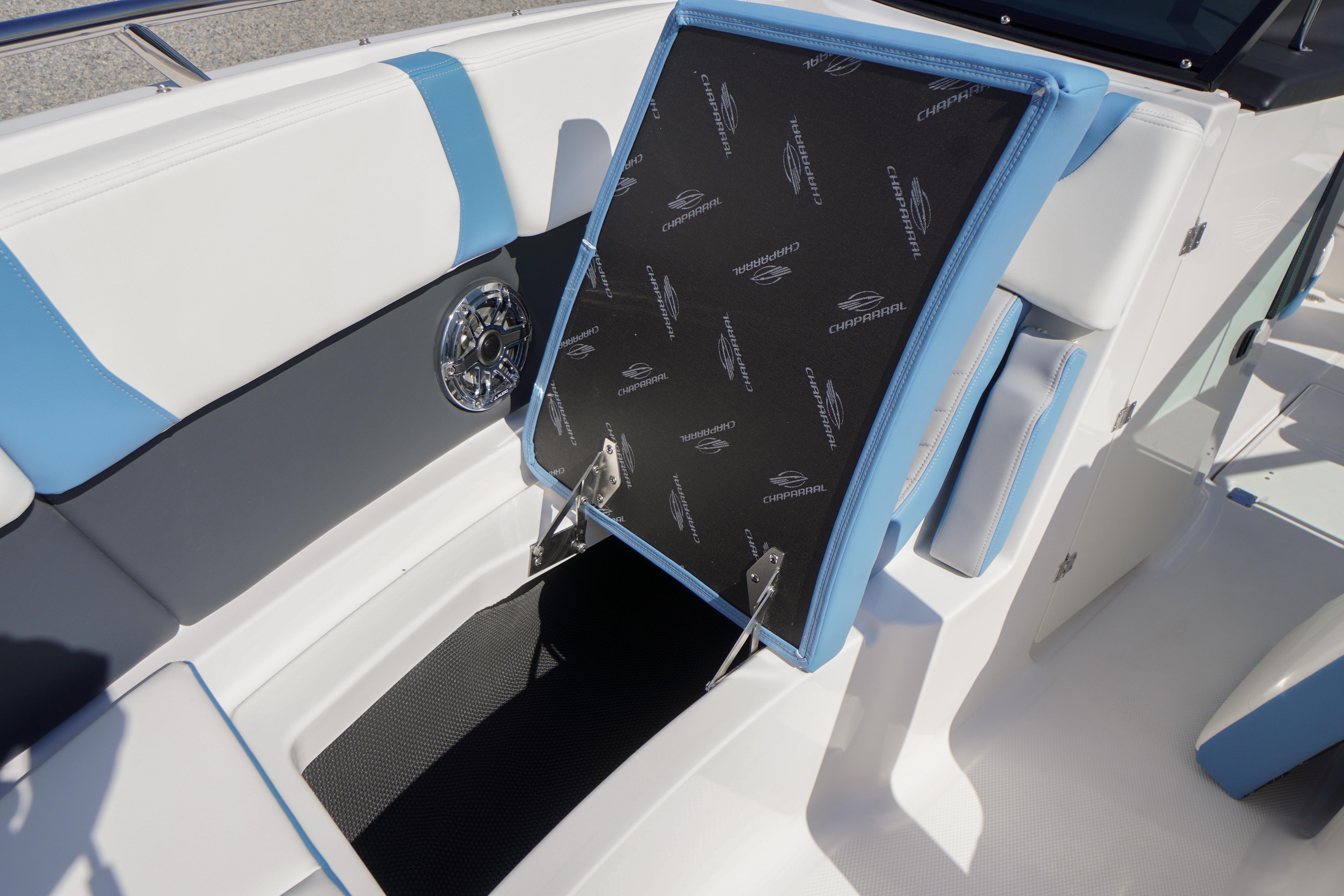 2026 Chaparral 270 OSX boat interior with open storage compartment and stylish seating.