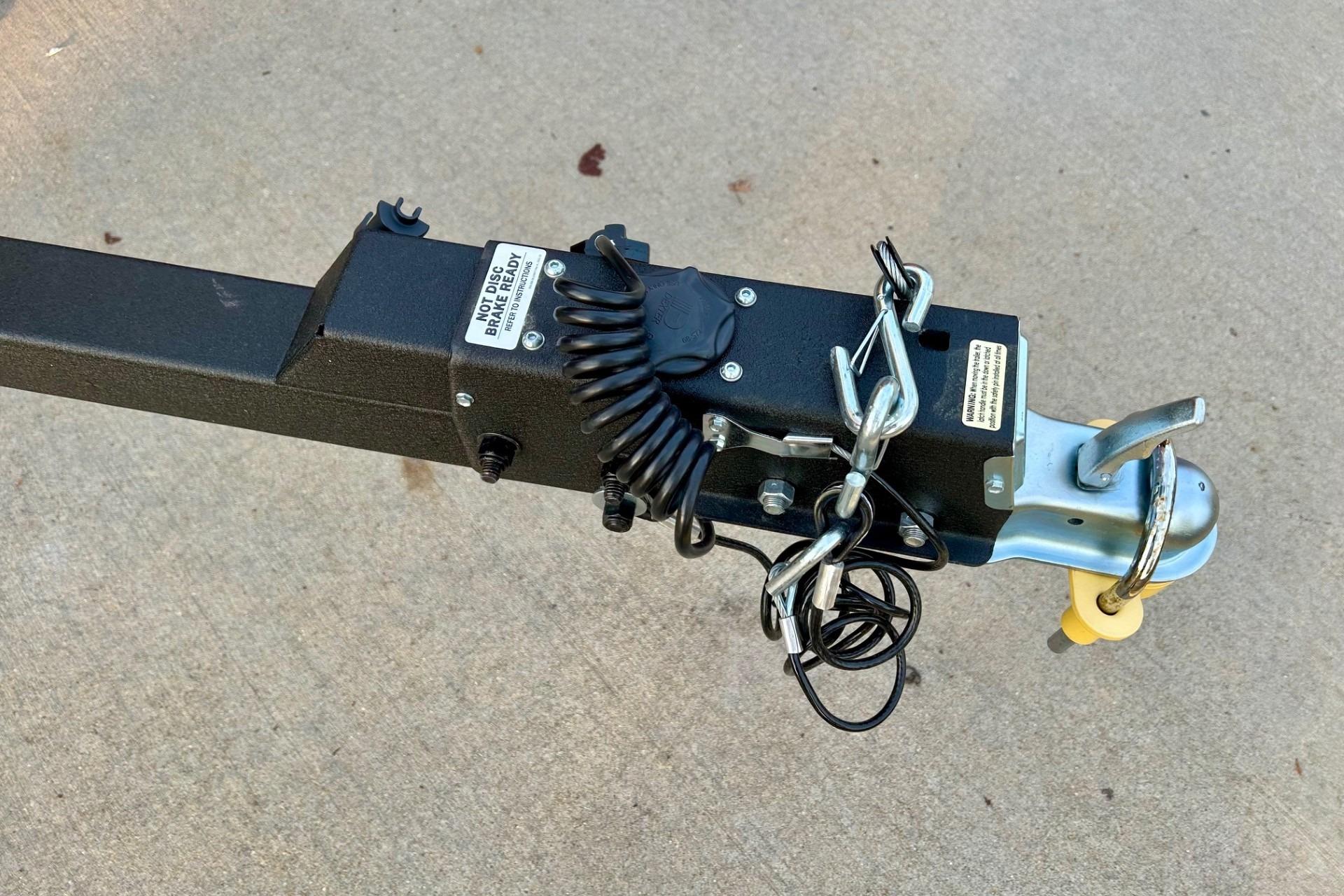 Trailer hitch of 2026 Tracker Super Guide V-16 SC on concrete surface.