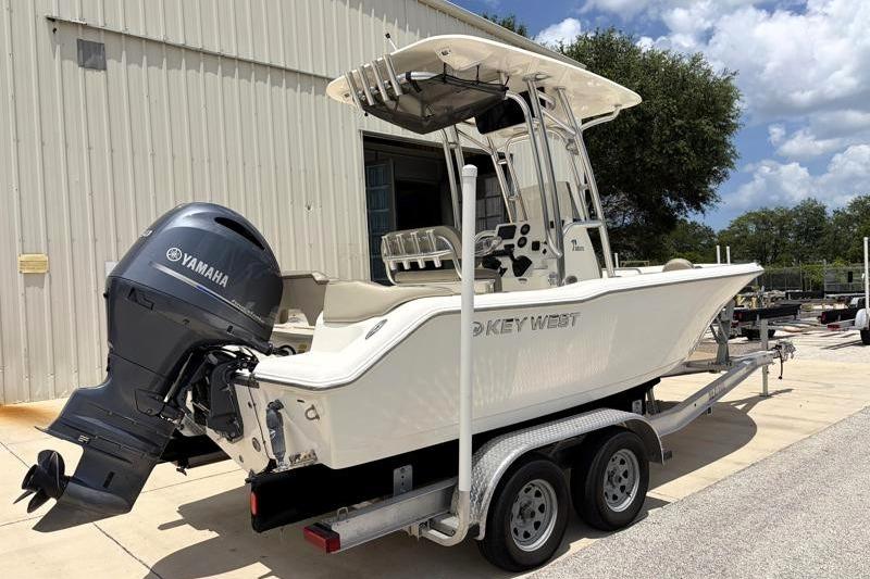2023 Key West 203 FS boat on trailer with Yamaha outboard motor, parked outdoors.
