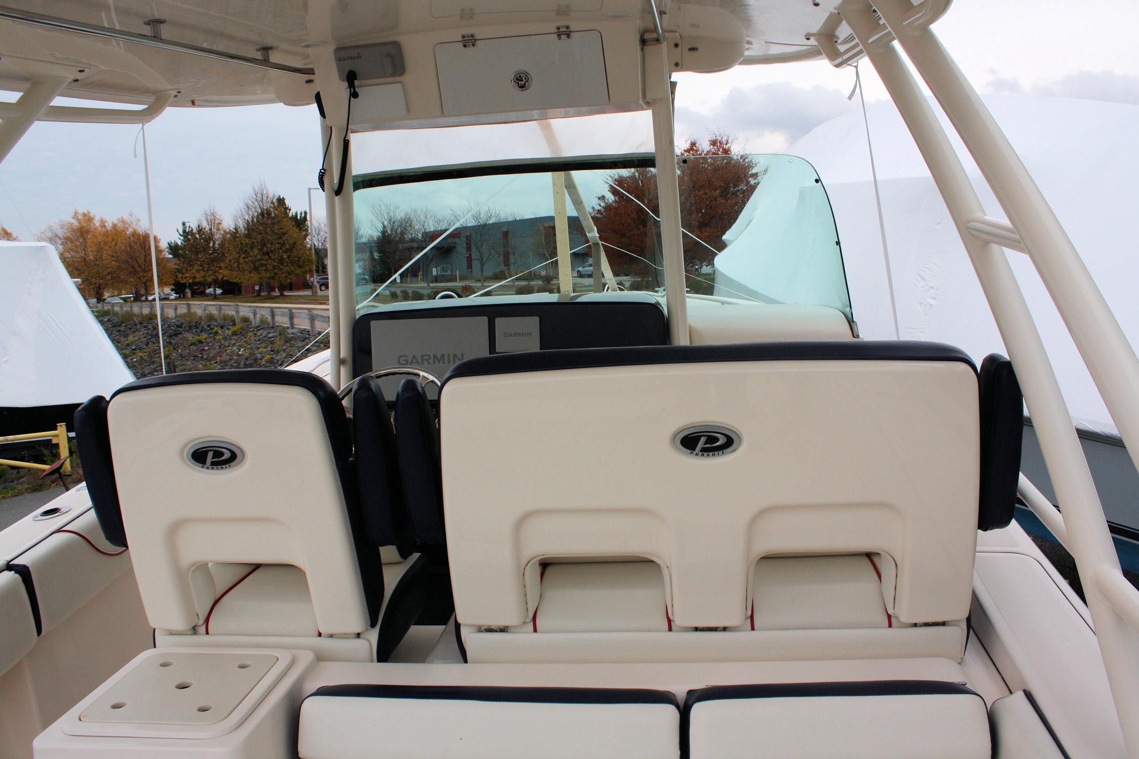 2013 Pursuit ST 310 Sport boat interior with dual seats and Garmin navigation system.