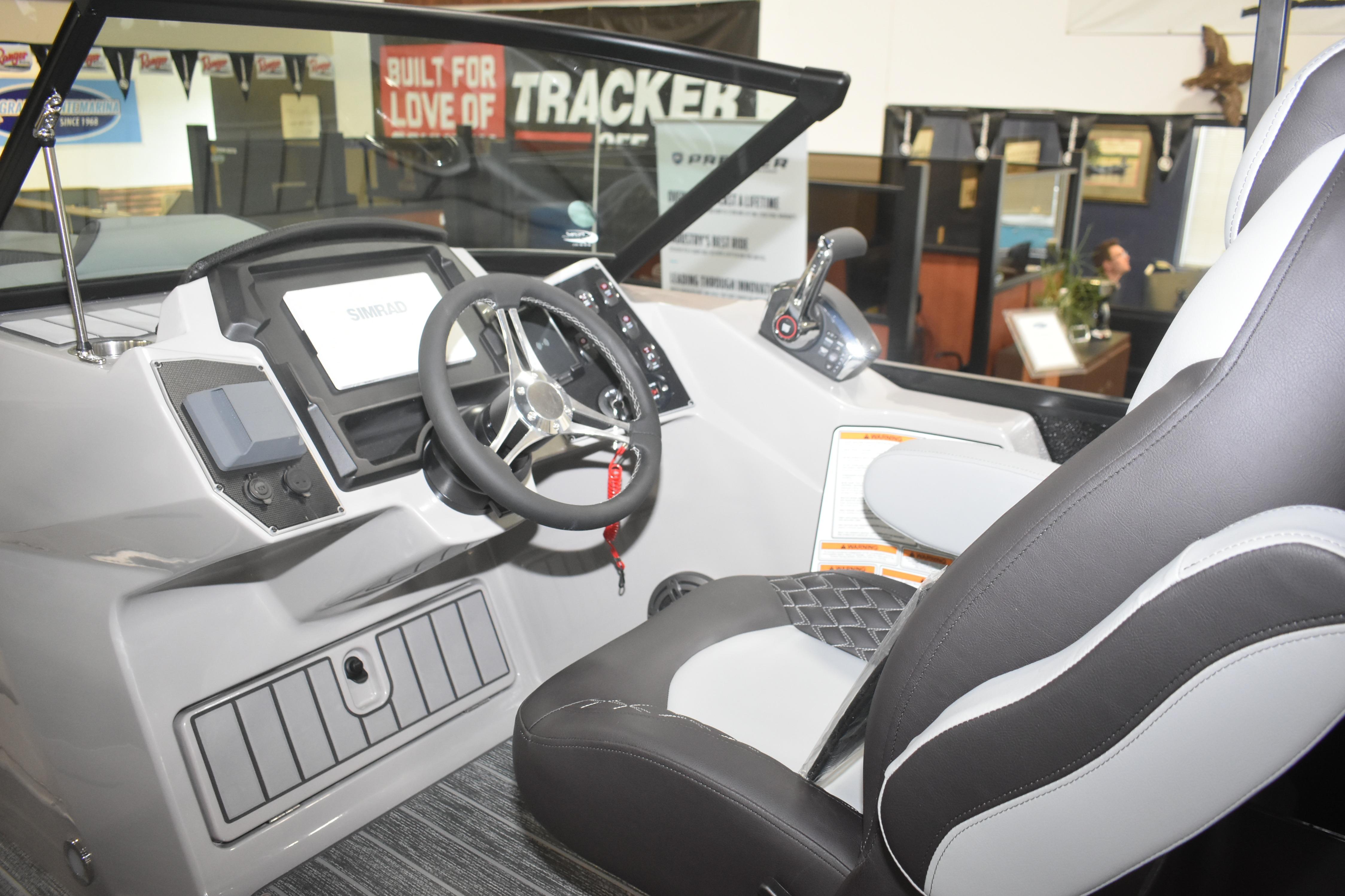 Interior of 2026 Premier 250 Solaris Sport boat, featuring modern steering and controls.