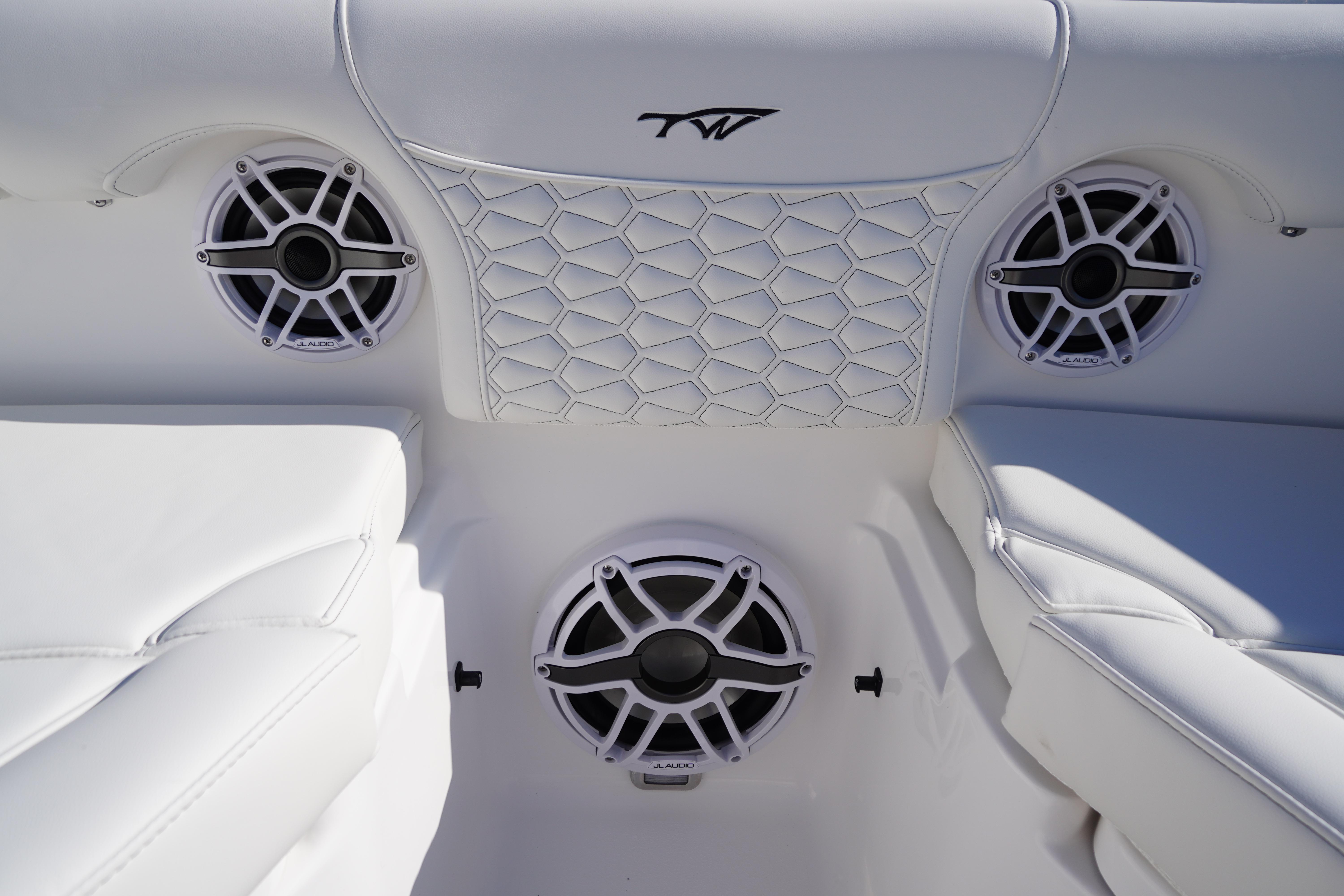 2026 Tidewater 272 LXF boat interior with JL Audio speakers and stylish white seating.