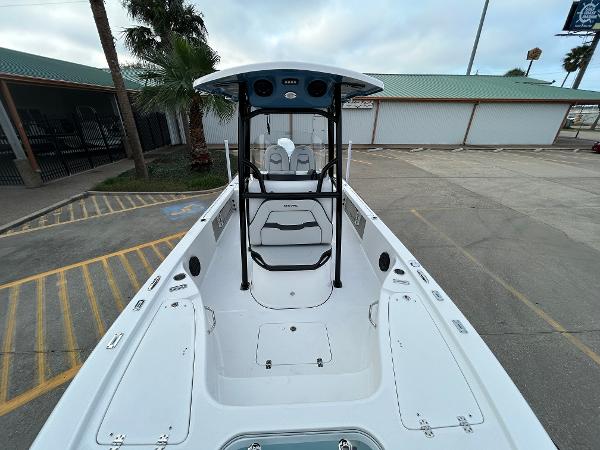 2024 Sea Pro 250 DLX boat, white interior, parked outdoors.