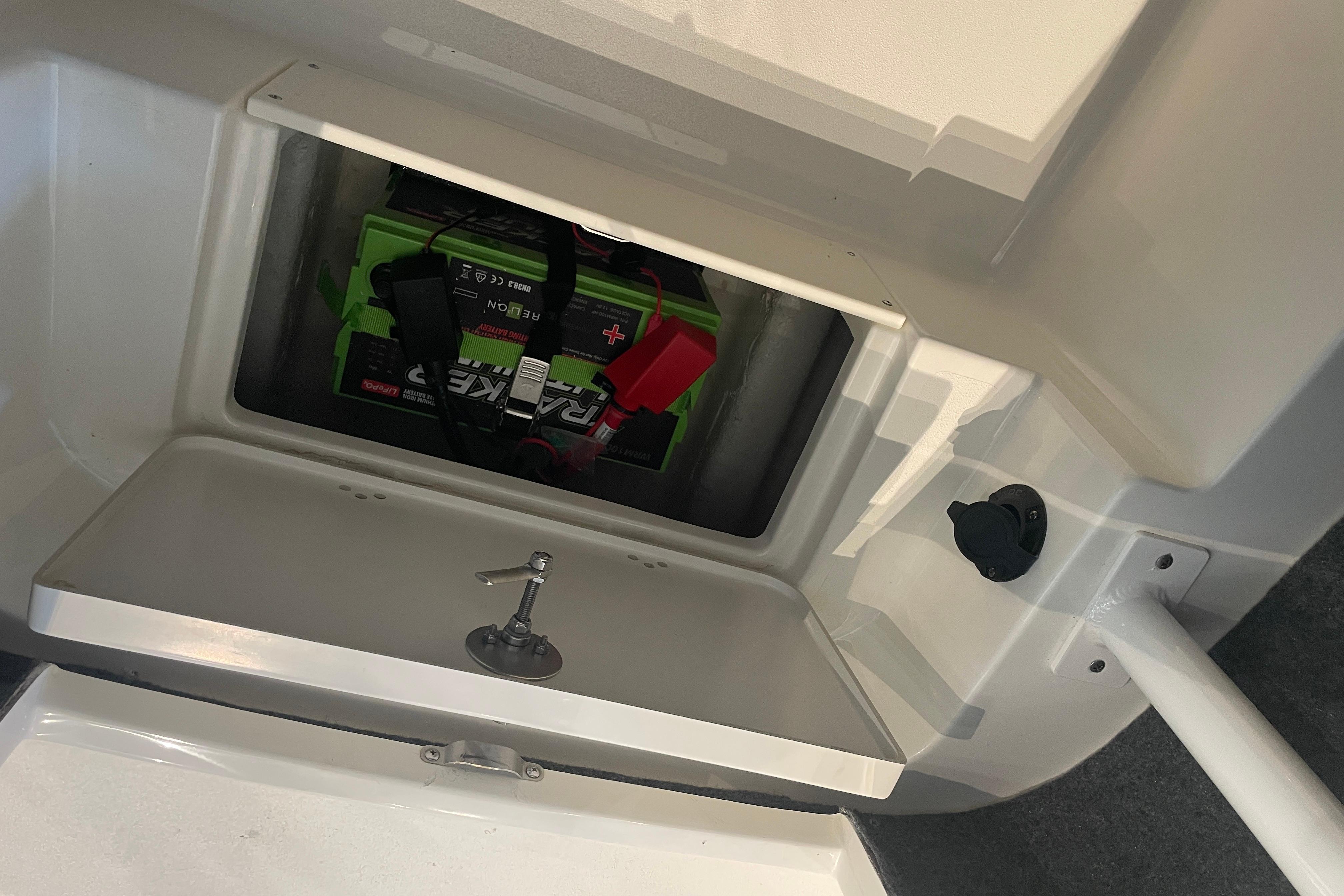 Battery compartment of 2026 Mako 226 Center Console boat, featuring secure storage.