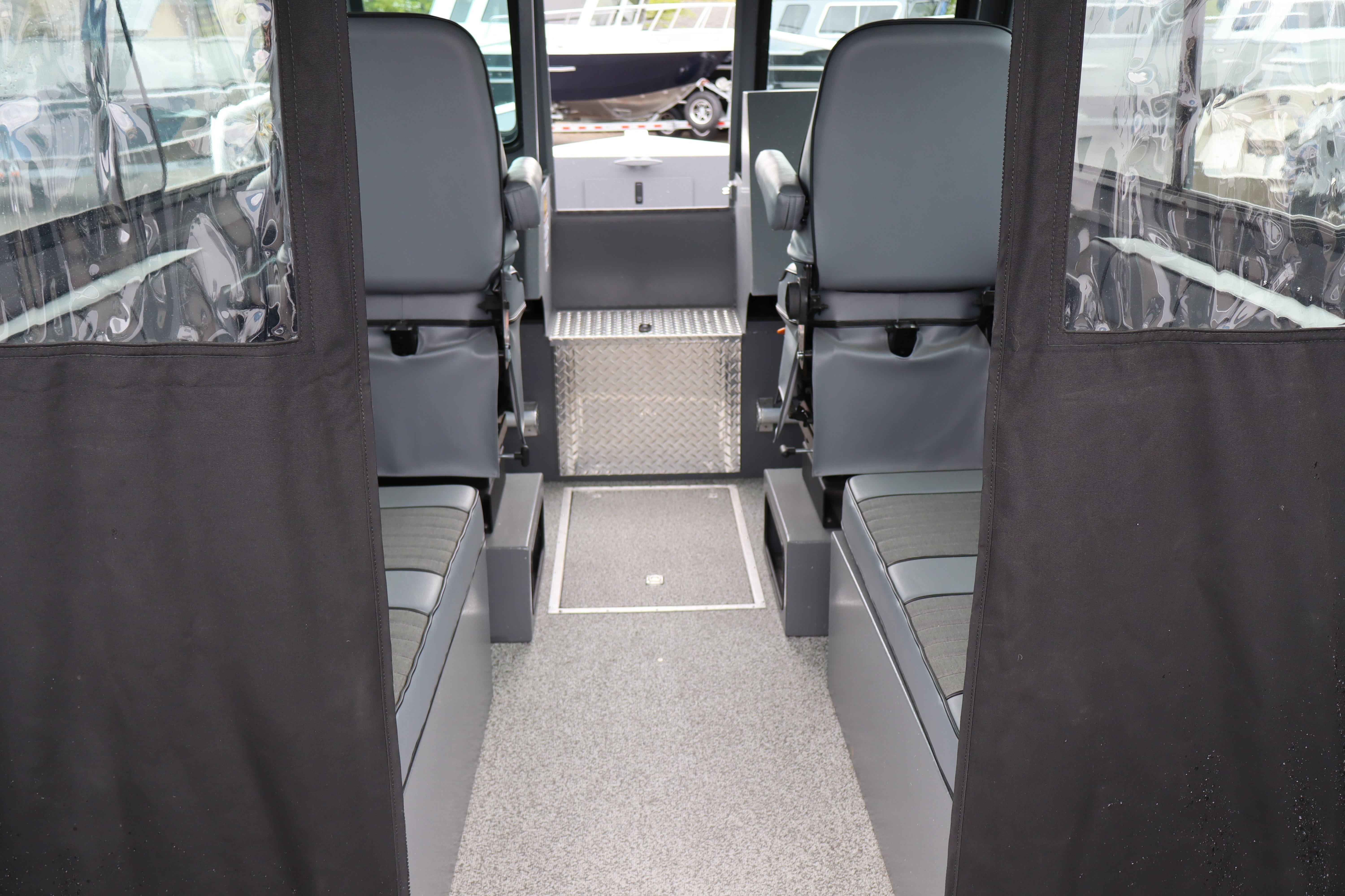 Interior of 2026 Alumaweld Horizon 24 boat with seating and windows.