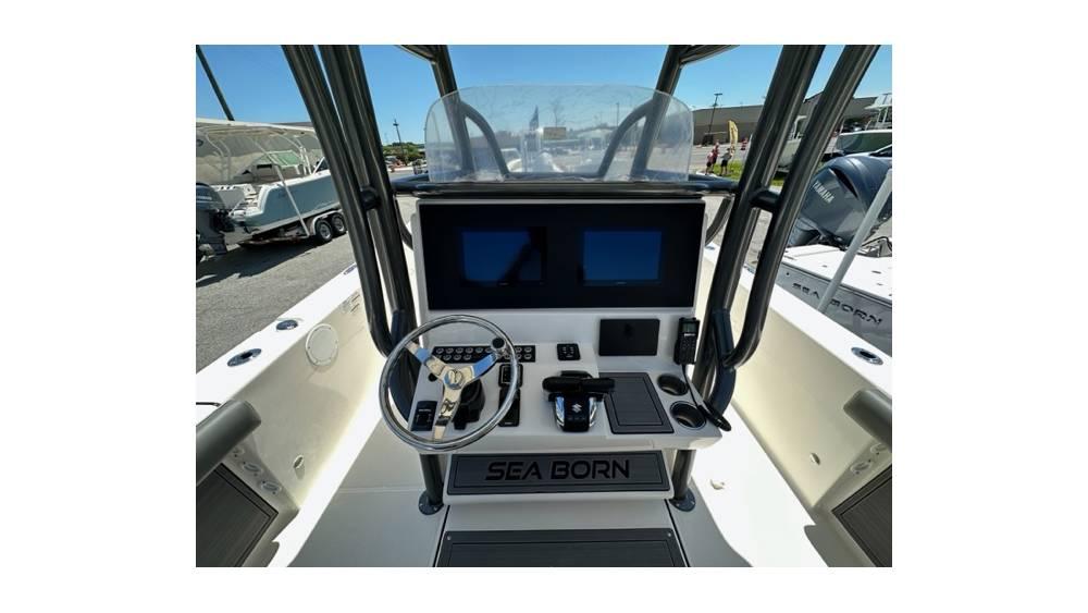 2024 Sea Born FX25 Bay boat dashboard with steering wheel and digital displays.