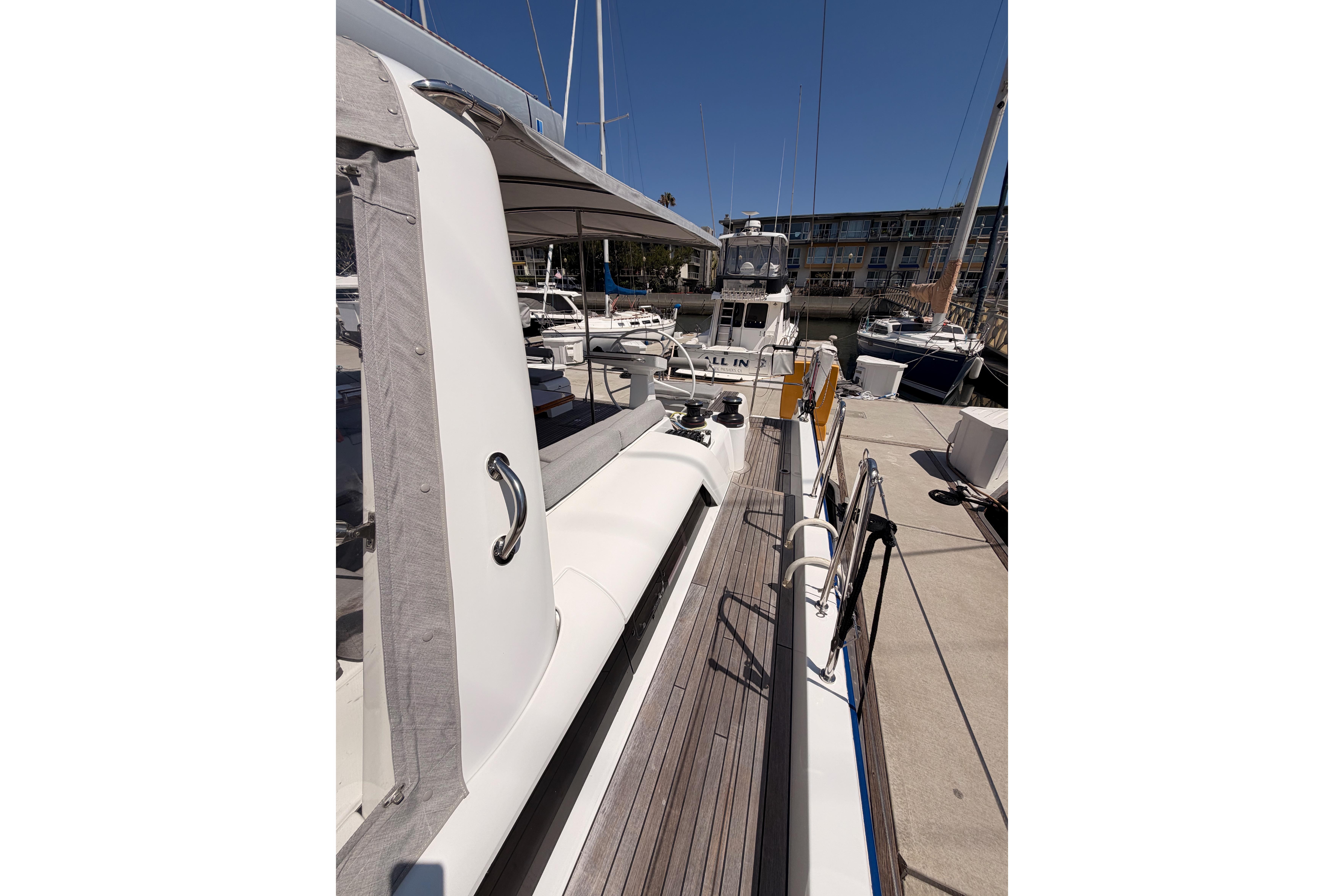 2022 Beneteau Oceanis Yacht 54 docked at marina, showcasing sleek deck design.