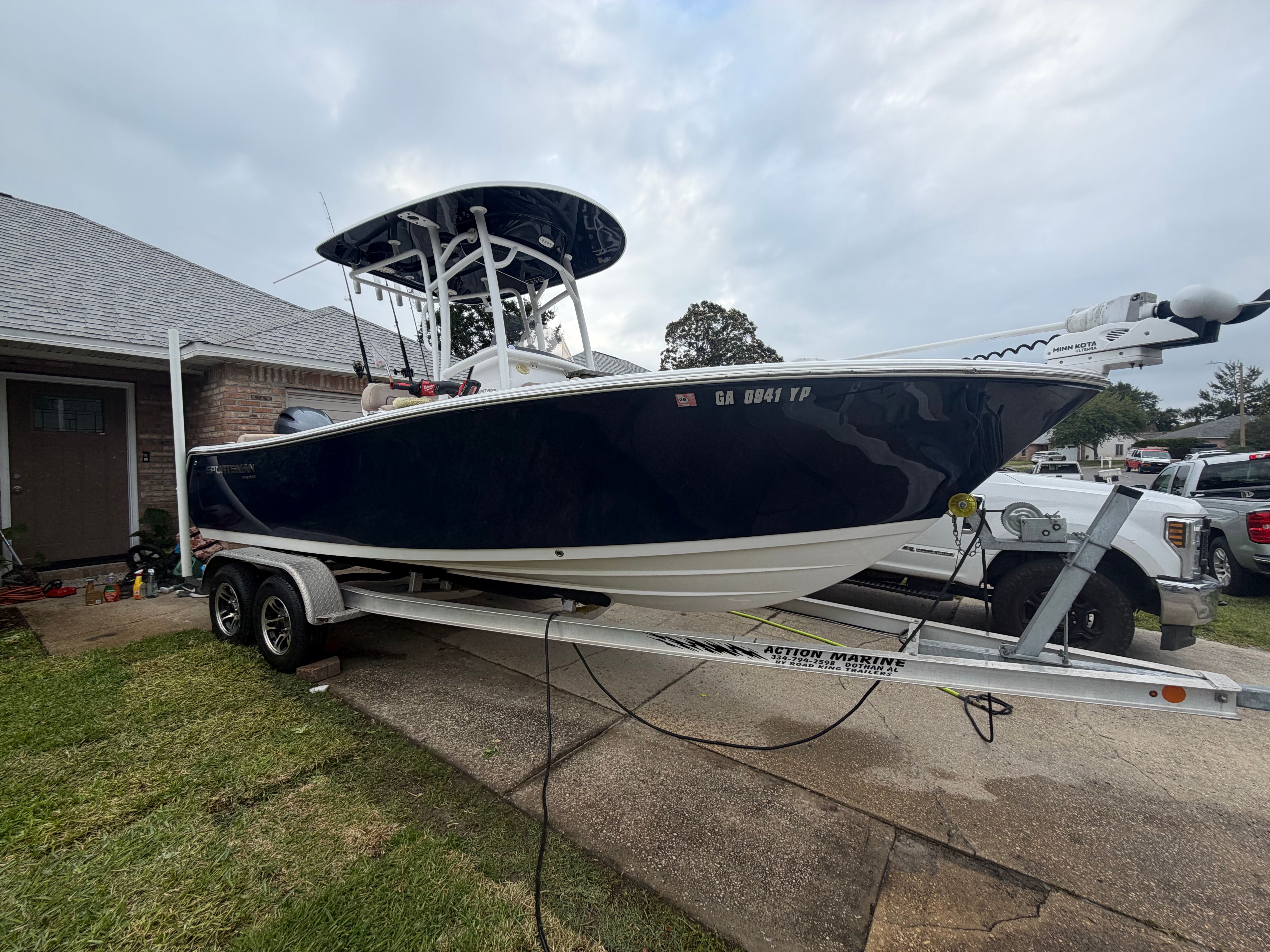 A 2020 Sportsman Heritage 211 Center Console boat on a trailer in a driveway.
