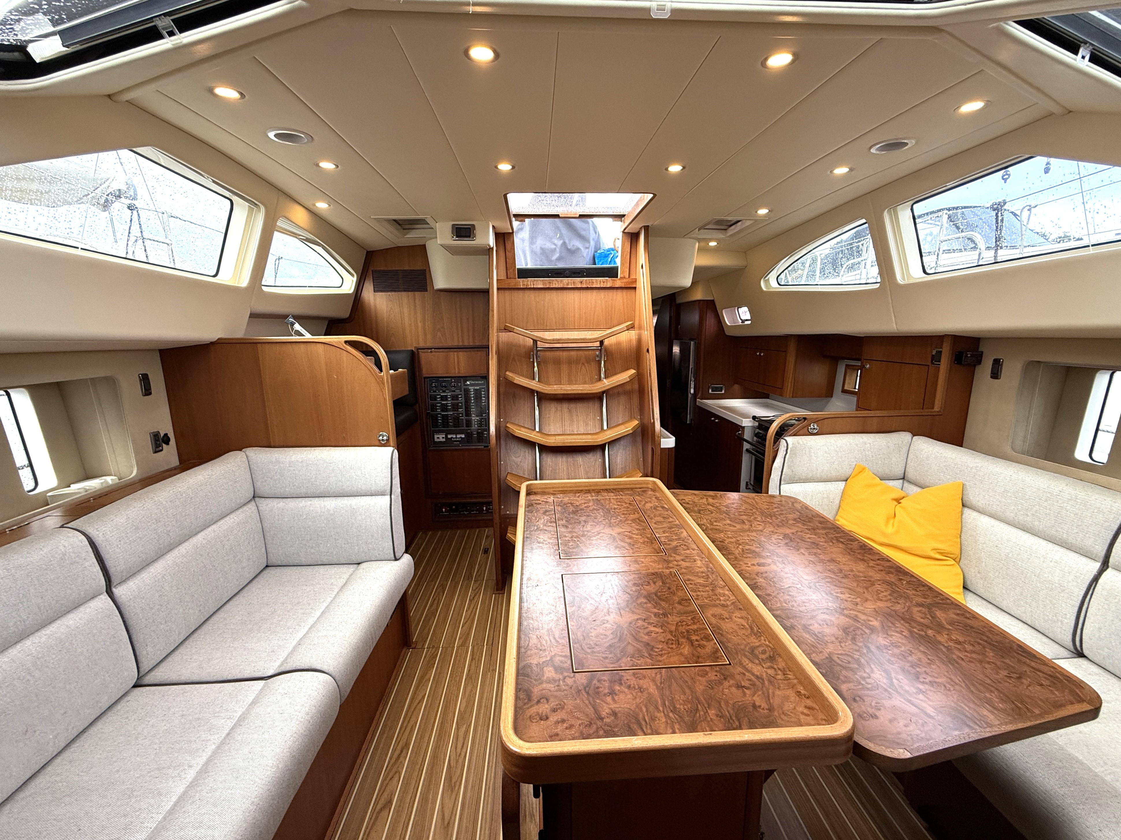 Luxurious interior of 2013 Southerly 420 yacht with elegant wood finishes and comfortable seating.