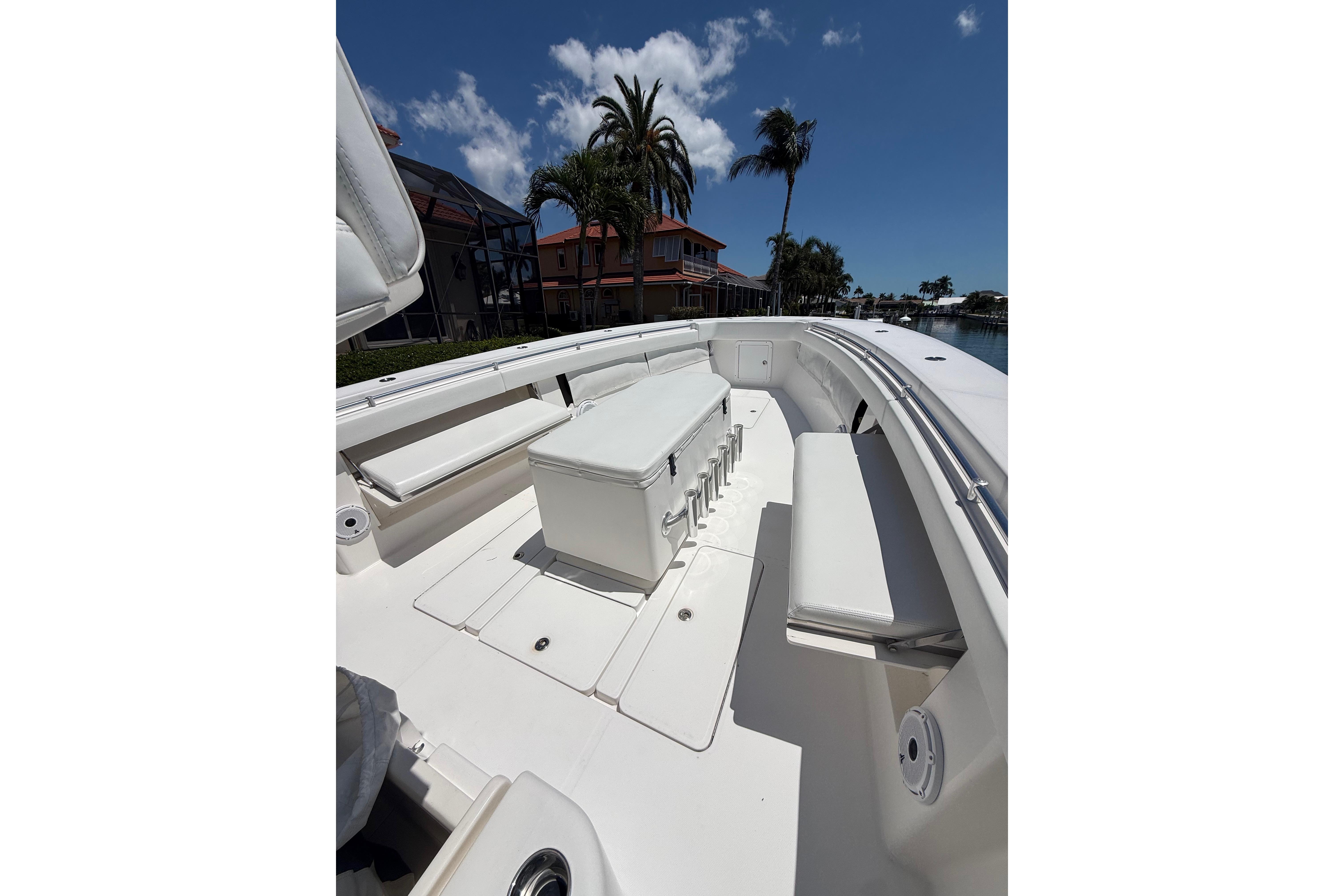 2012 Invincible 42 Open Fisherman boat interior with seating and storage under a clear blue sky.