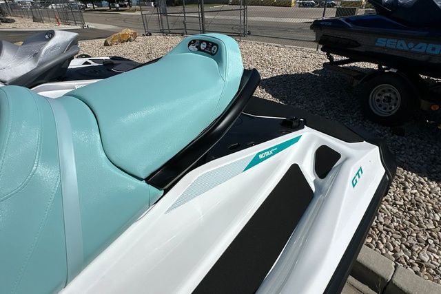 2026 Sea-Doo PWC GTI 130 WH IBR 26 STD with turquoise seat on gravel area.