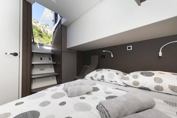 Interior of a 2021 Bali 4.8 yacht cabin with modern bedding and natural light.
