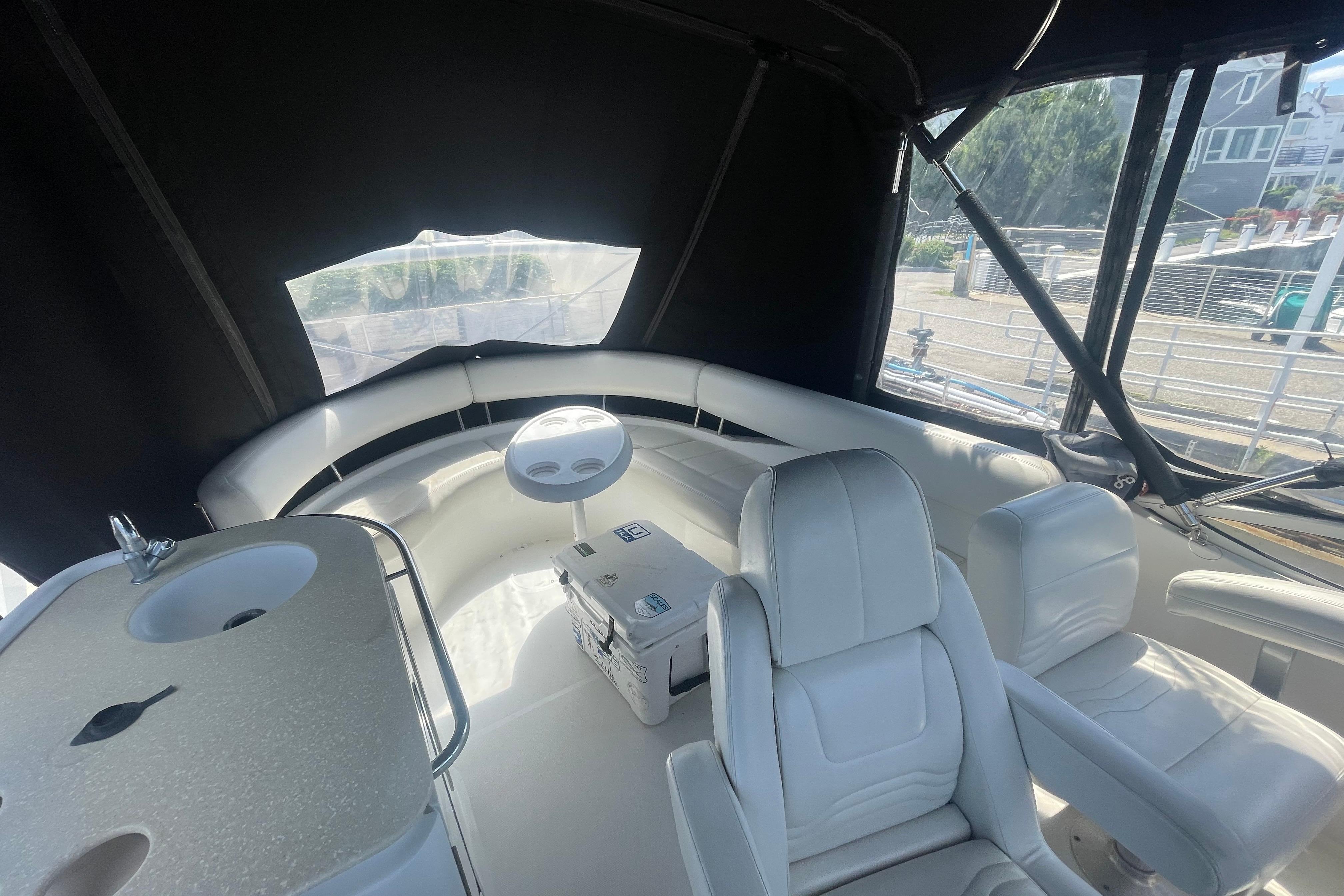 Interior of 2002 Carver 410 Sport Sedan with white seating and helm station.