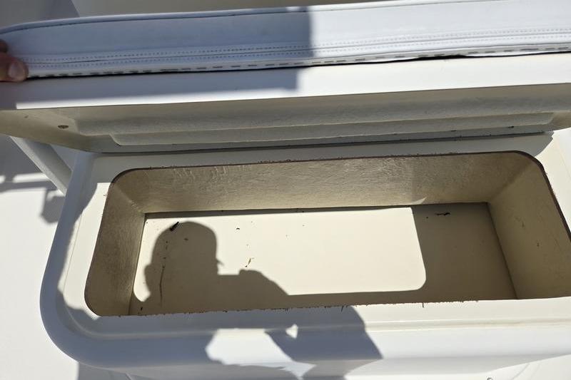 Open storage compartment on a 2000 May-Craft 2000CC boat.