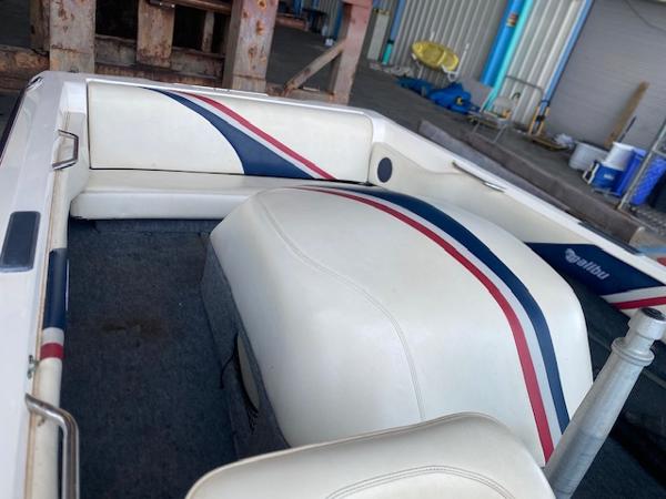 1998 Malibu Response boat interior with white, red, and blue upholstery in a garage setting.