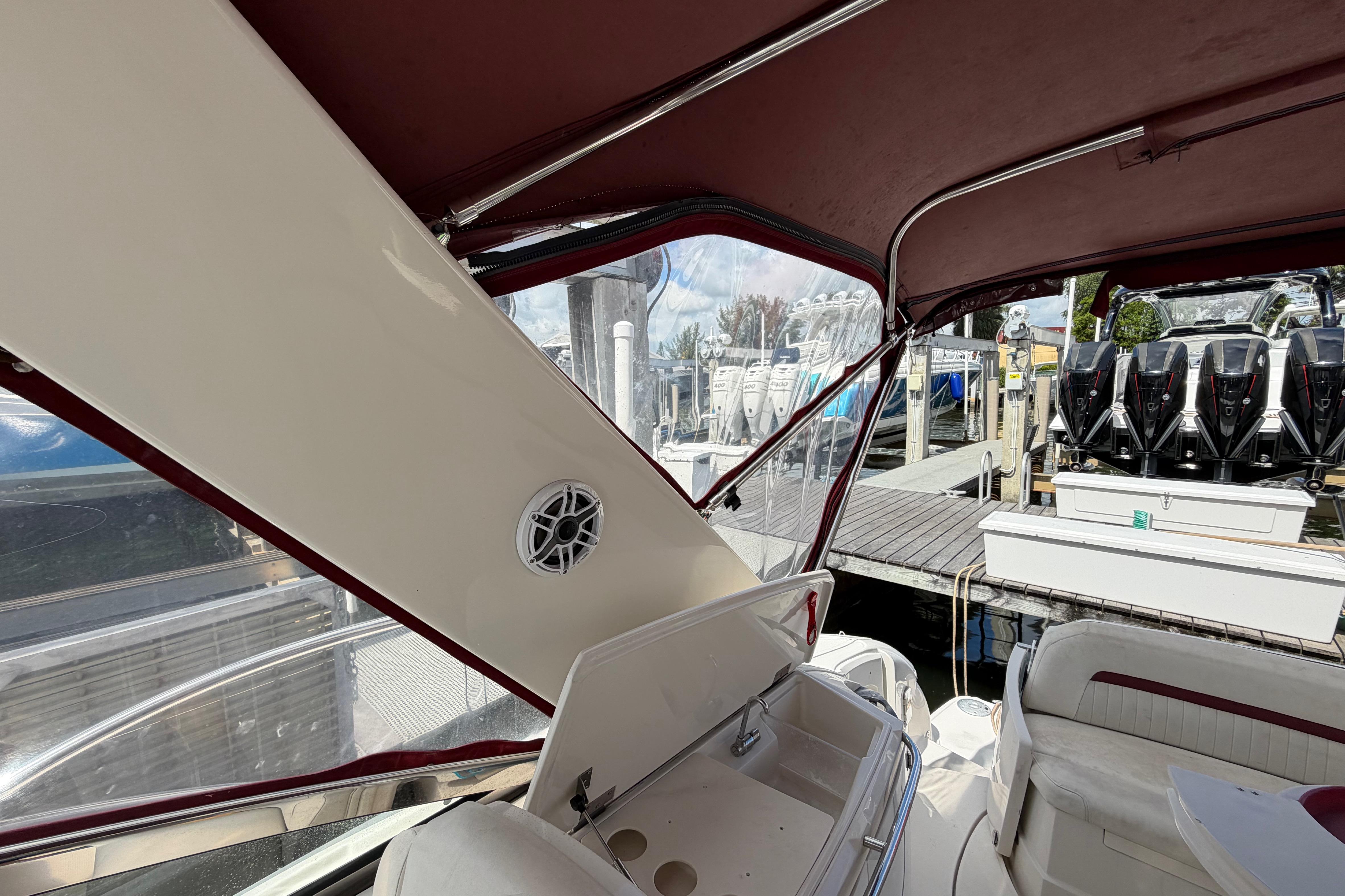 Interior view of a 2007 Monterey 350 Sport Yacht with maroon canopy and docked boats.