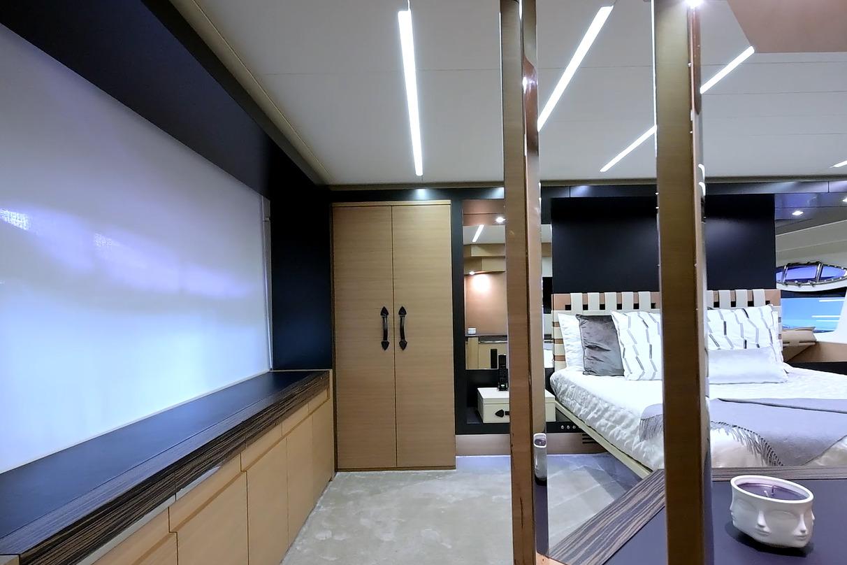 Luxurious interior of a 2015 Pershing 92 yacht bedroom with modern design elements.