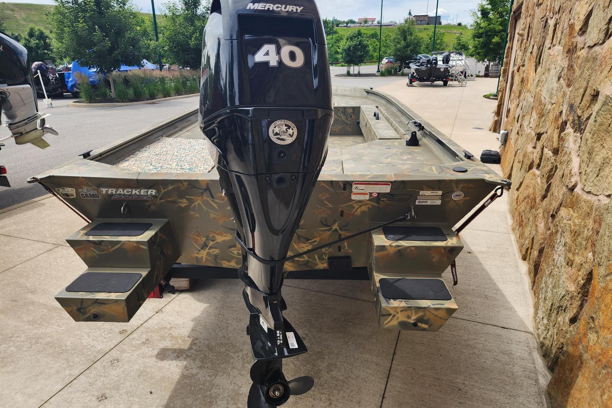 2022 GRIZZLEY 1654SPT boat with Mercury 40 engine, parked outdoors.