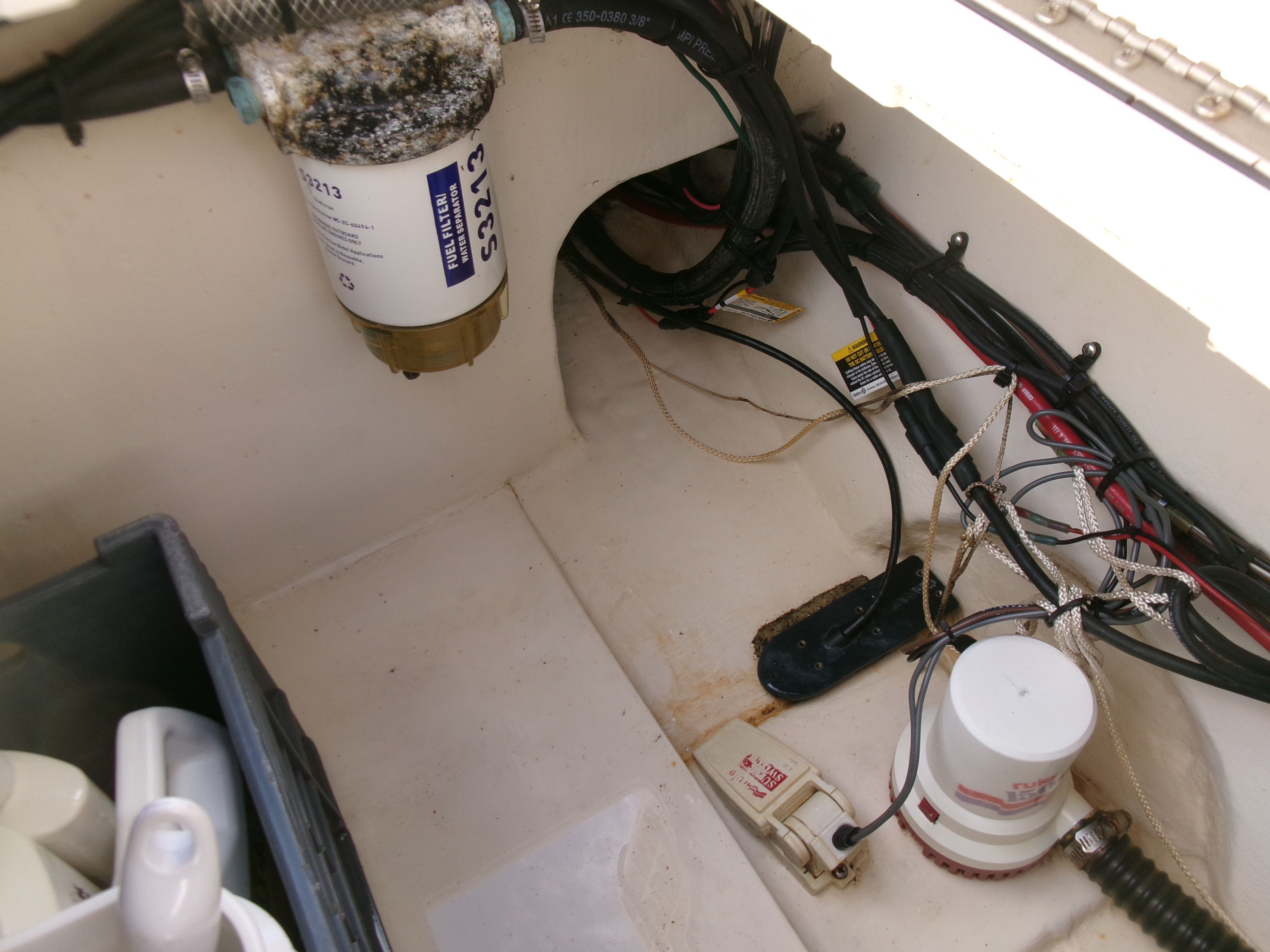A view inside the engine compartment of a 2007 Parker 2520 XL Sport Cabin boat with cables and filters.