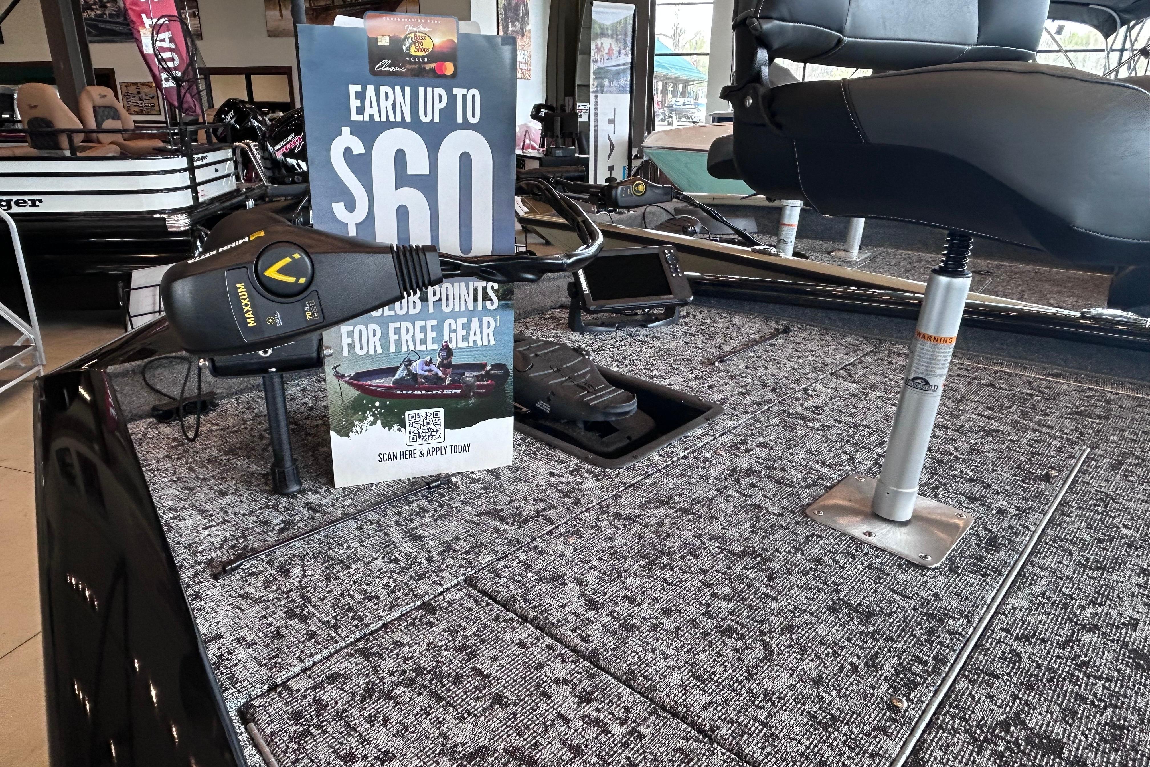 2026 Tracker Pro Team 195 boat interior with promotional sign and fishing gear.