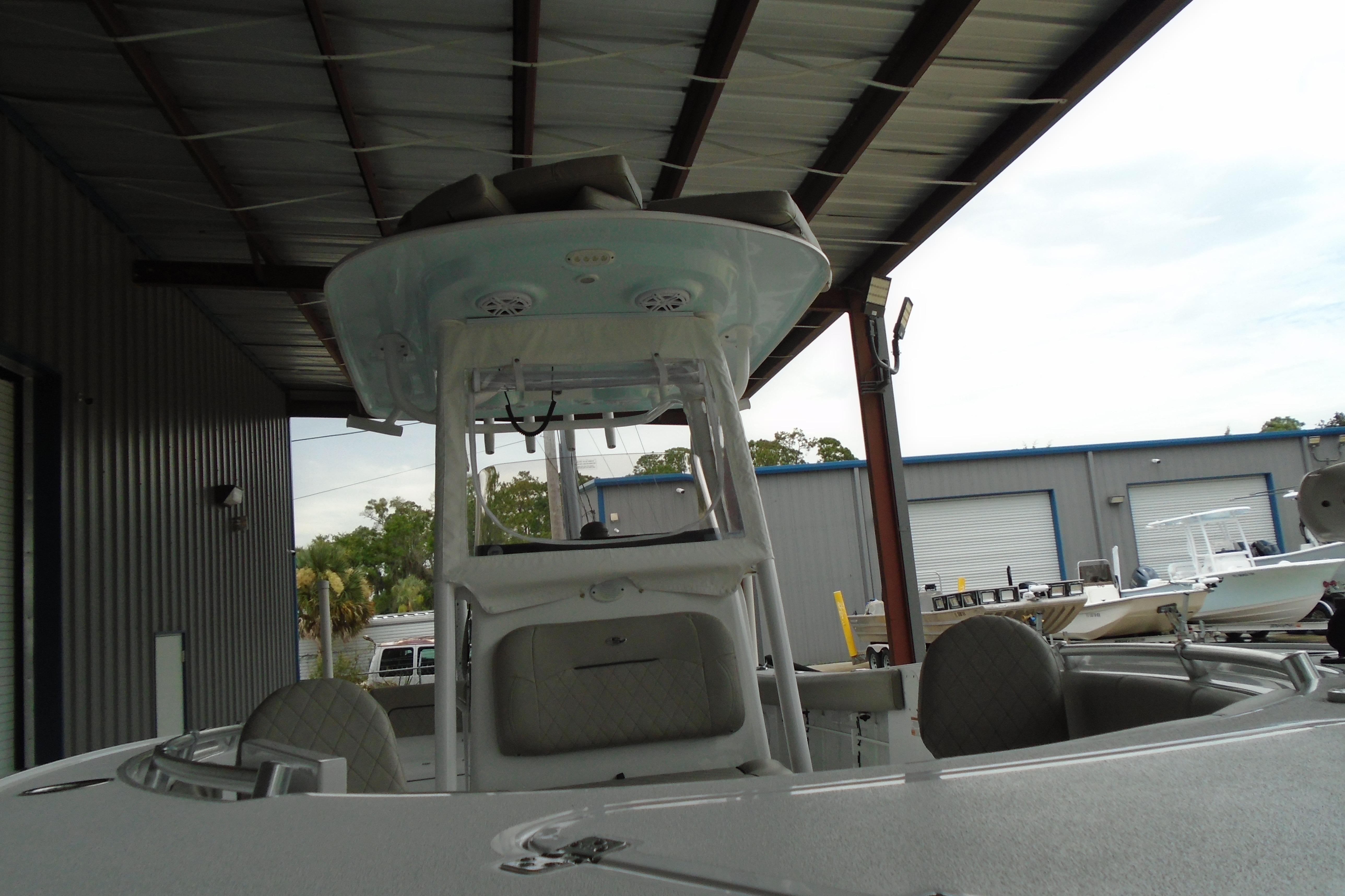 2022 Sportsman Heritage 241 Center Console boat under a metal canopy.