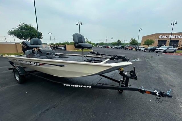 2026 Tracker Pro 170 boat on trailer in parking lot near boat service center.